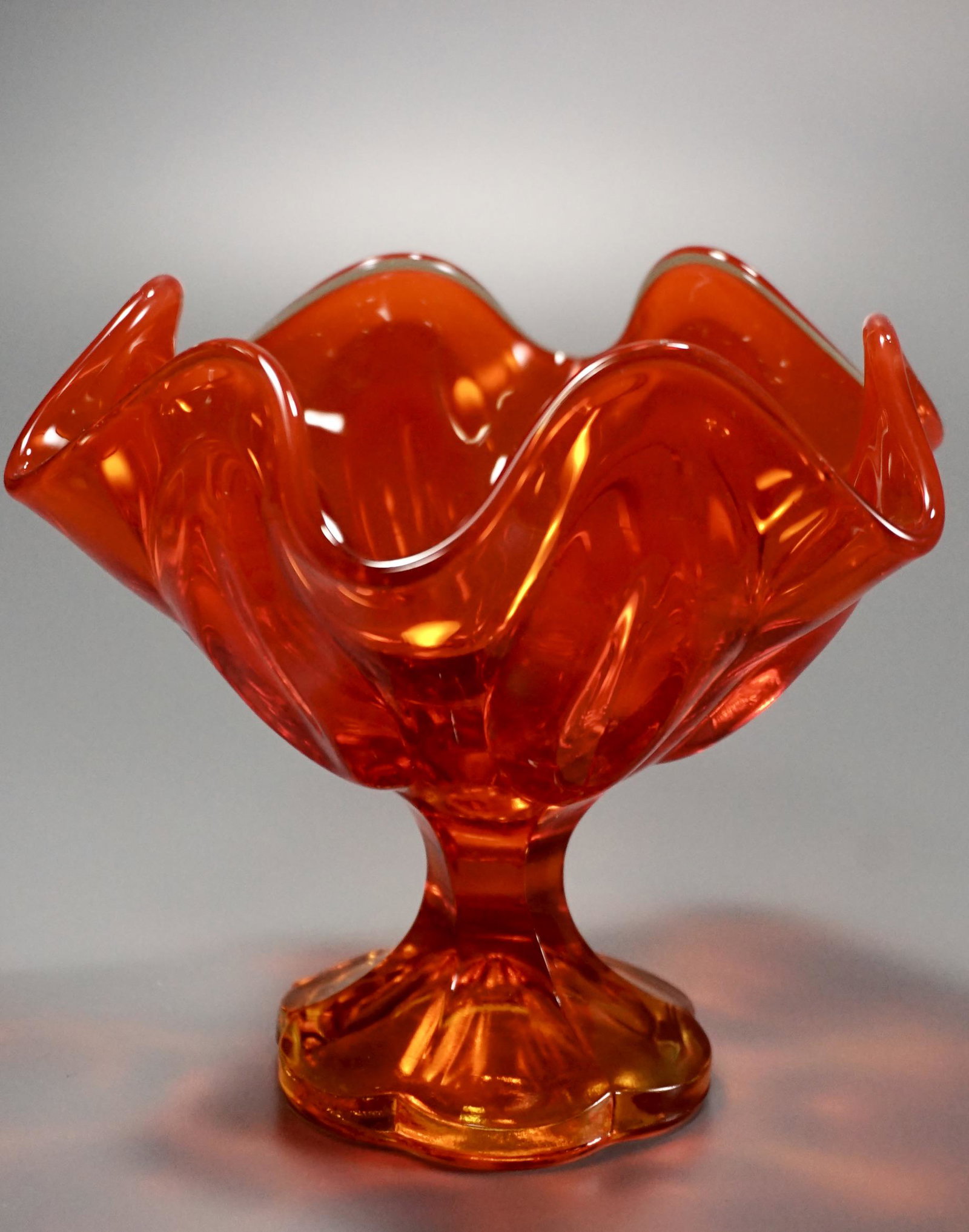 Mid Century Amber Orange Glass Compote: Mid Century Amber Orange Glass Compote Approximately 7 3/8 inches in diameter x 5 3/8 inches tall.