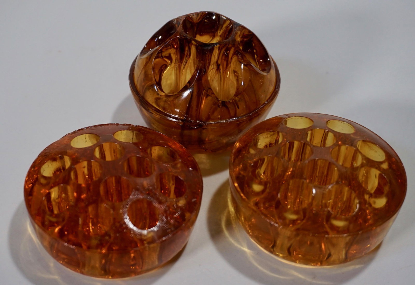 Vintage English Amber Glass Flower Frog Together with: Vintage English Amber Glass Flower Frog Together with Vintage Davidson Cloud Amber Slag Art Glass Flower Frog Lot of 3 items Approximately 2 3/8 inches in diameter and 2 1/2 inches in diameter.