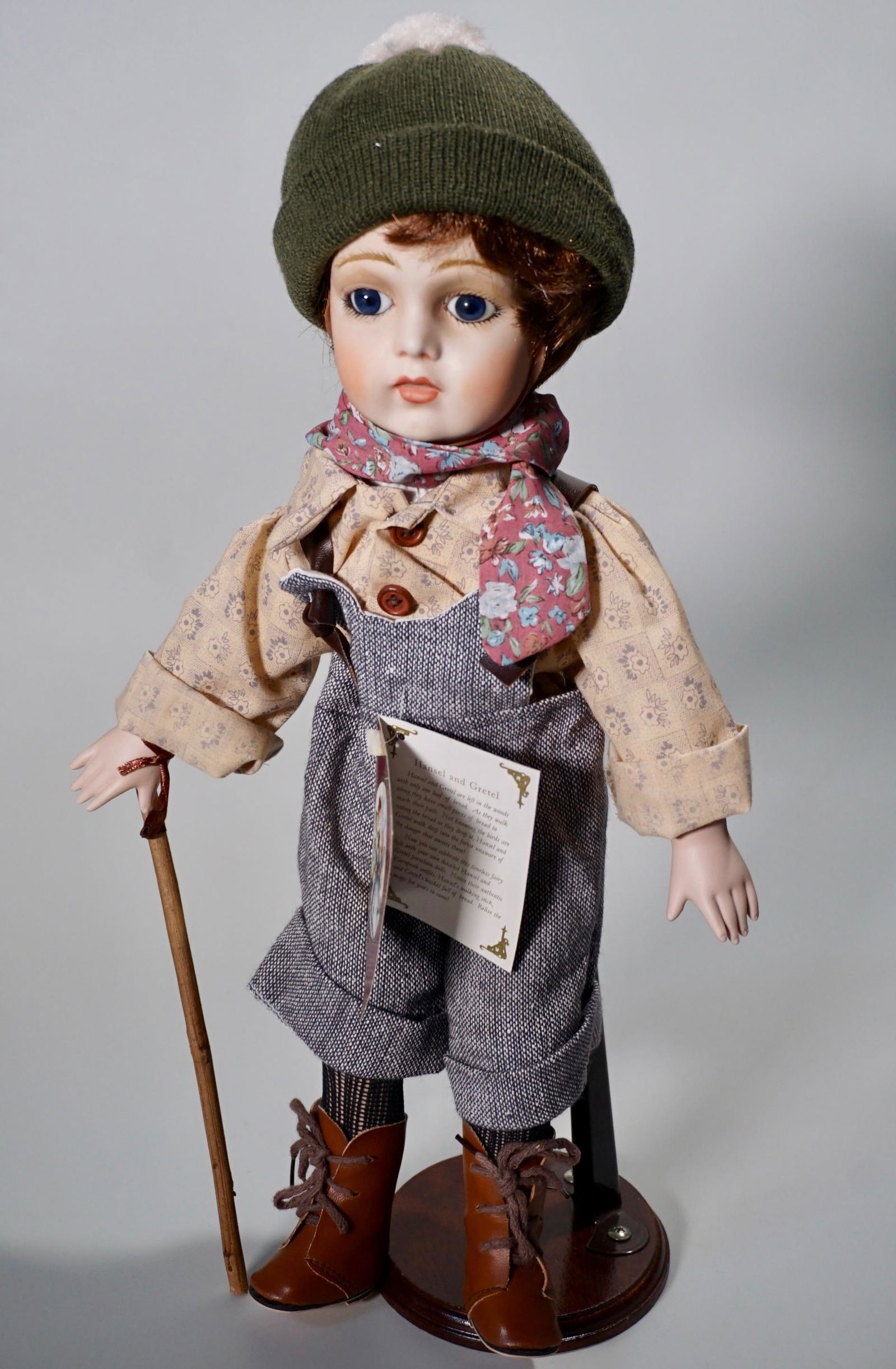 Porcelain Head Hansel Fairytale Doll By Geppeddo Hansel: Porcelain Head Hansel Fairytale Doll By Geppeddo Hansel and Gretel Collectable Doll on Display Stand Approximately 17 1/2 inches tall.