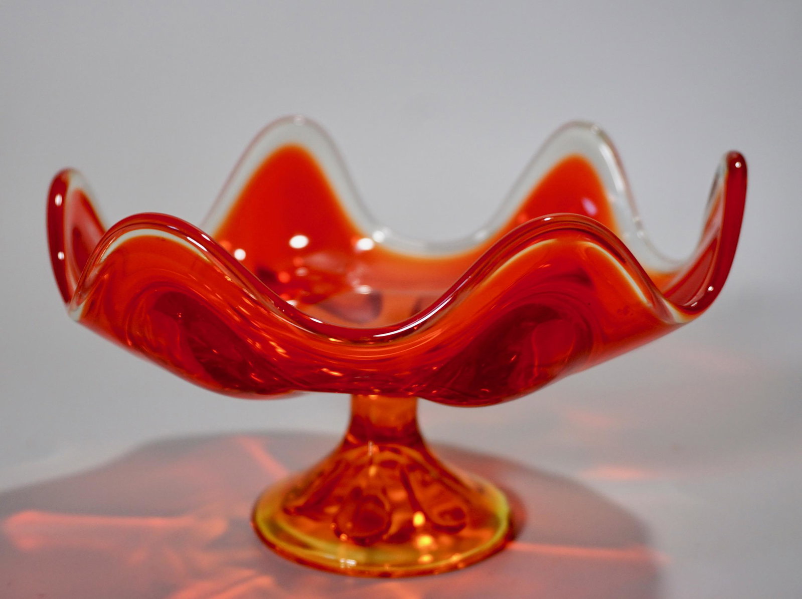 Vintage Orange Glass Compote Footed Bowl: Vintage Orange Glass Compote Footed Bowl Approximately 4 3/8 inches tall x 7 5/16 inches in diameter.