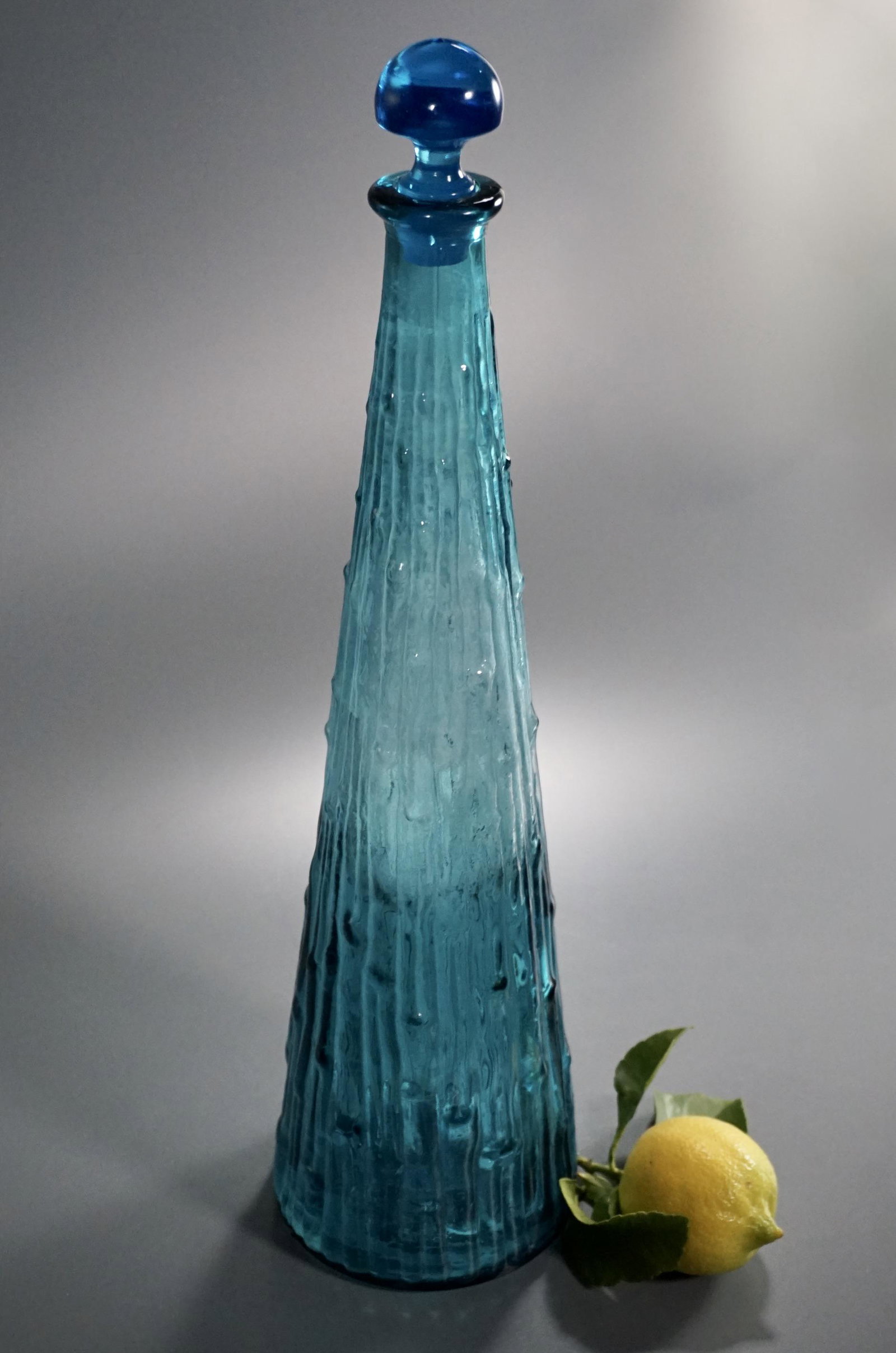 Mid Century Tall Blue Glass Genie Bottle Decanter: Mid Century Tall Blue Glass Genie Bottle Decanter Approximately 16 7/8 inches tall overall.