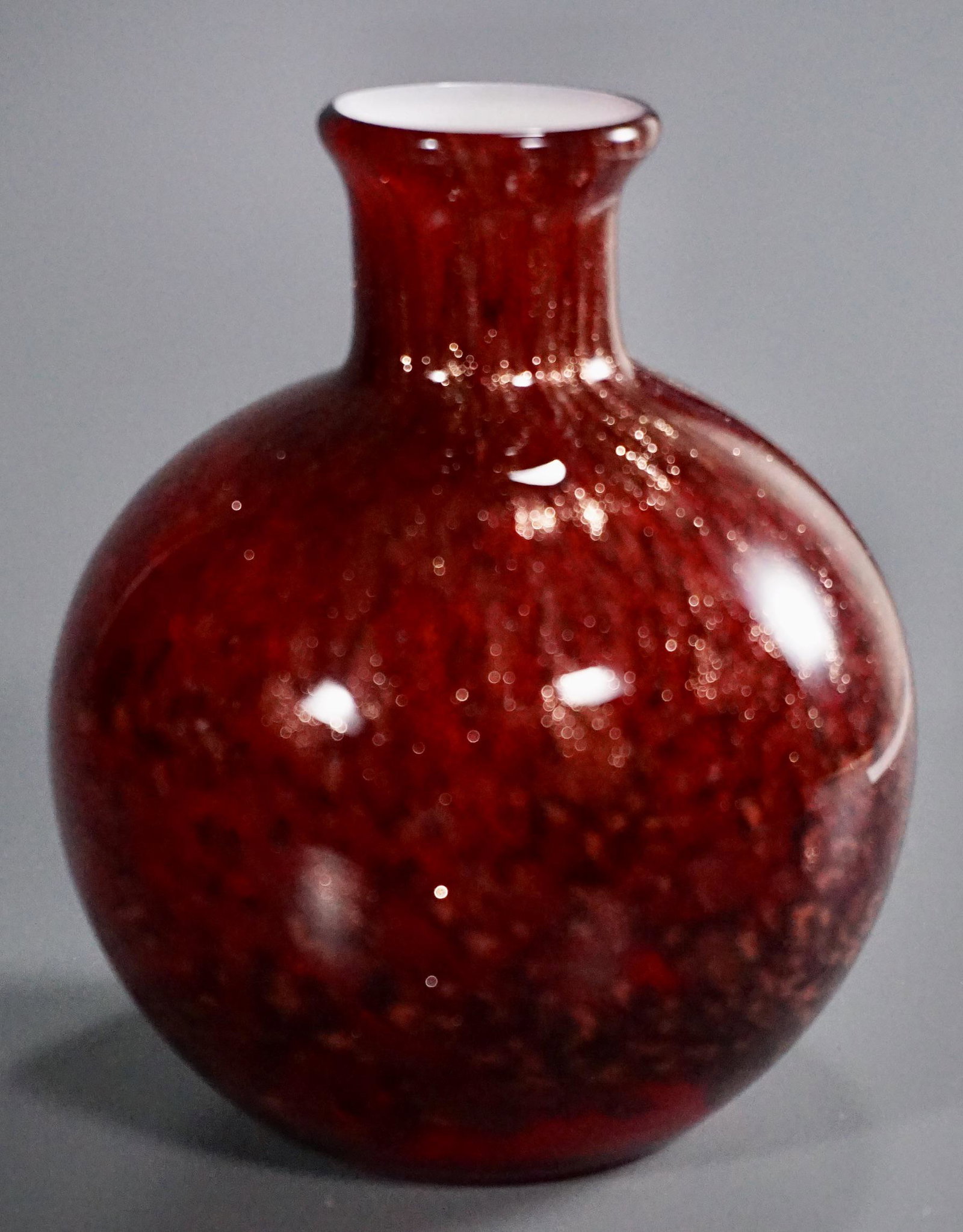 Ruby Cased Art Glass Gold Speckled Bottle Vase: Ruby Cased Art Glass Gold Speckled Bottle Vase Approximately 4 7/8 inches tall.