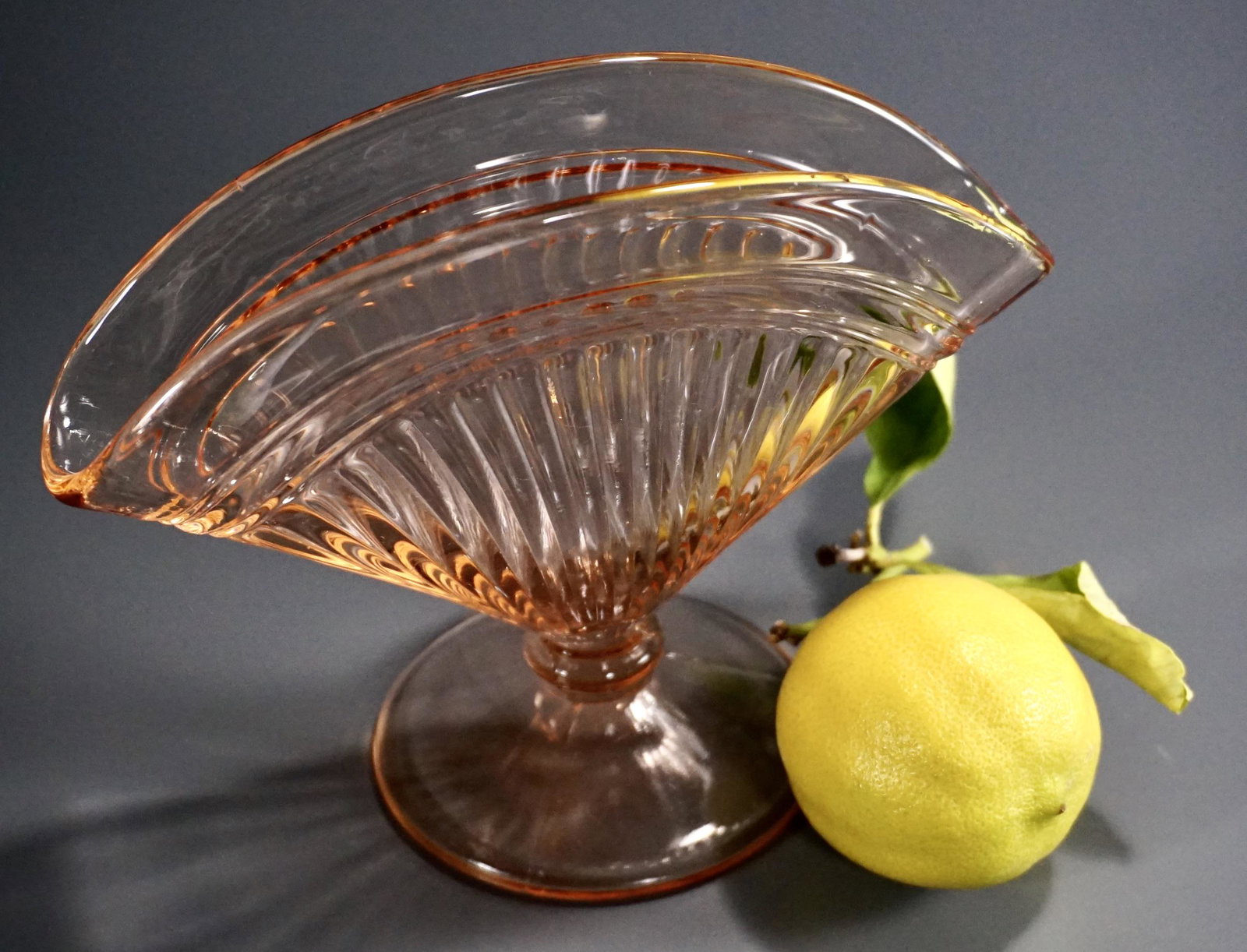 Art Deco Pink Pressed Glass Fan Vase: Art Deco Pink Pressed Glass Fan Vase Approximately 1 3/4 x 6 5/8 x 5 7/16 inches tall; the base is about 3 1/4 inches in diameter.