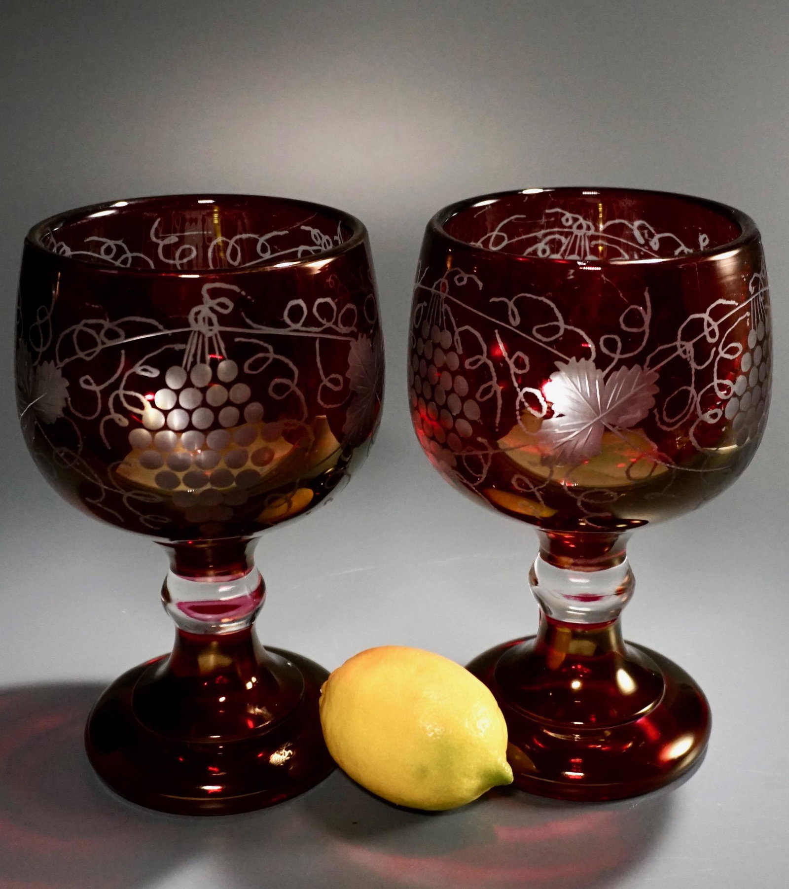 Bohemian Style Glass Ruby Splashed Large Pokal Vase: Bohemian Style Glass Ruby Splashed Large Pokal Vase Grape Wines Motif Egerman Goblet Lot of 2 Approximately 8 1/8 inches tall.