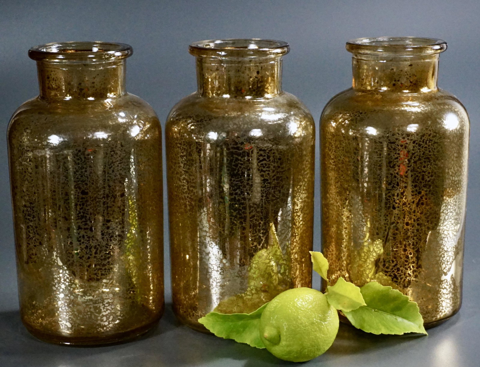Gold Mercury Glass Apothecary Jar Lot of 3: Gold Mercury Glass Apothecary Jar Lot of 3 Approximately 4 inches in diameter x 7 3/4 inches tall.