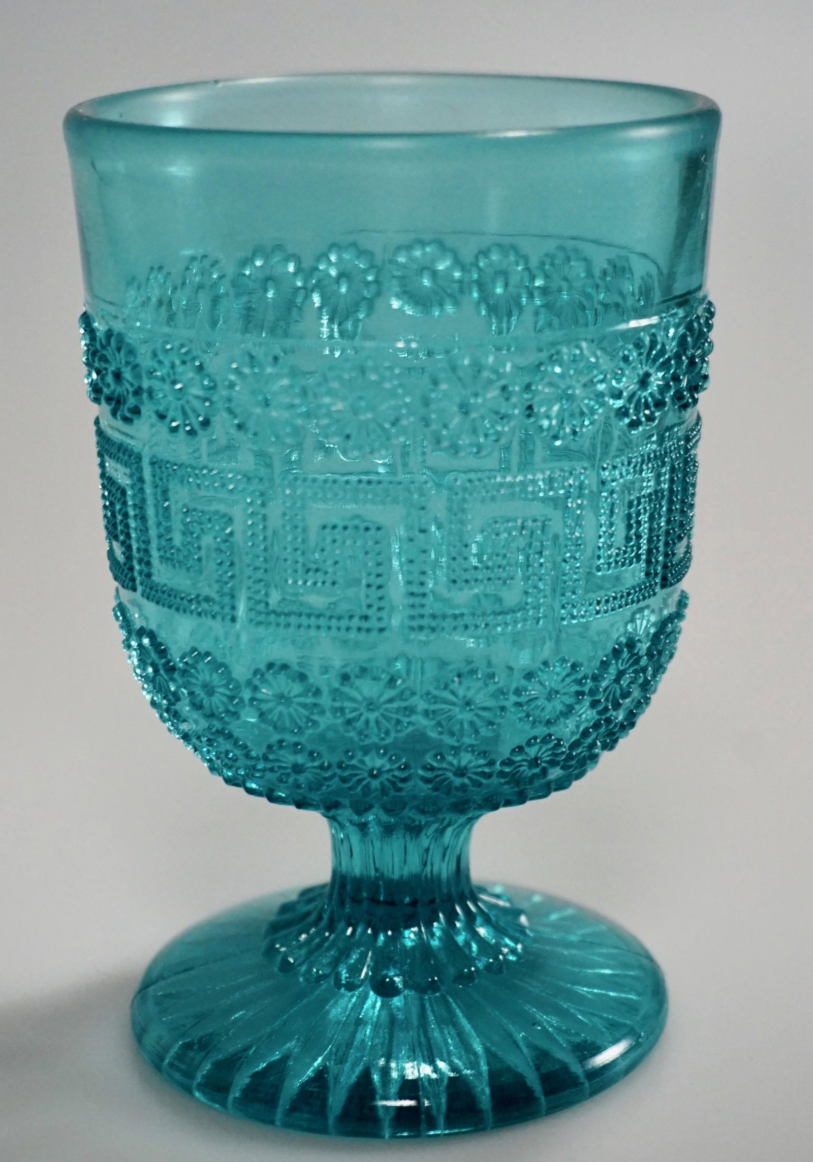 Greek Key Blue Pressed Glass Antique Footed Vase: Greek Key Blue Pressed Glass Antique Footed Vase Approximately 4 1/2 inches tall.