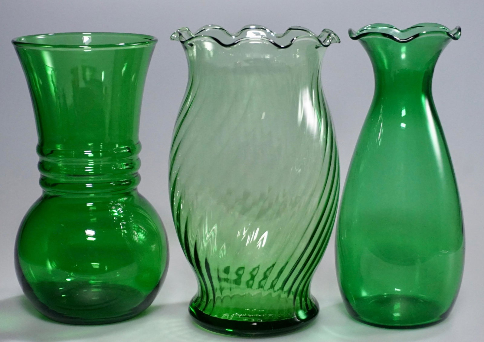 Lot of 3 Vintage Green Glass Vases: Lot of 3 Vintage Green Glass Vases Approximately 6 3/8; 6 5/8 and 6 5/8 inches tall.
