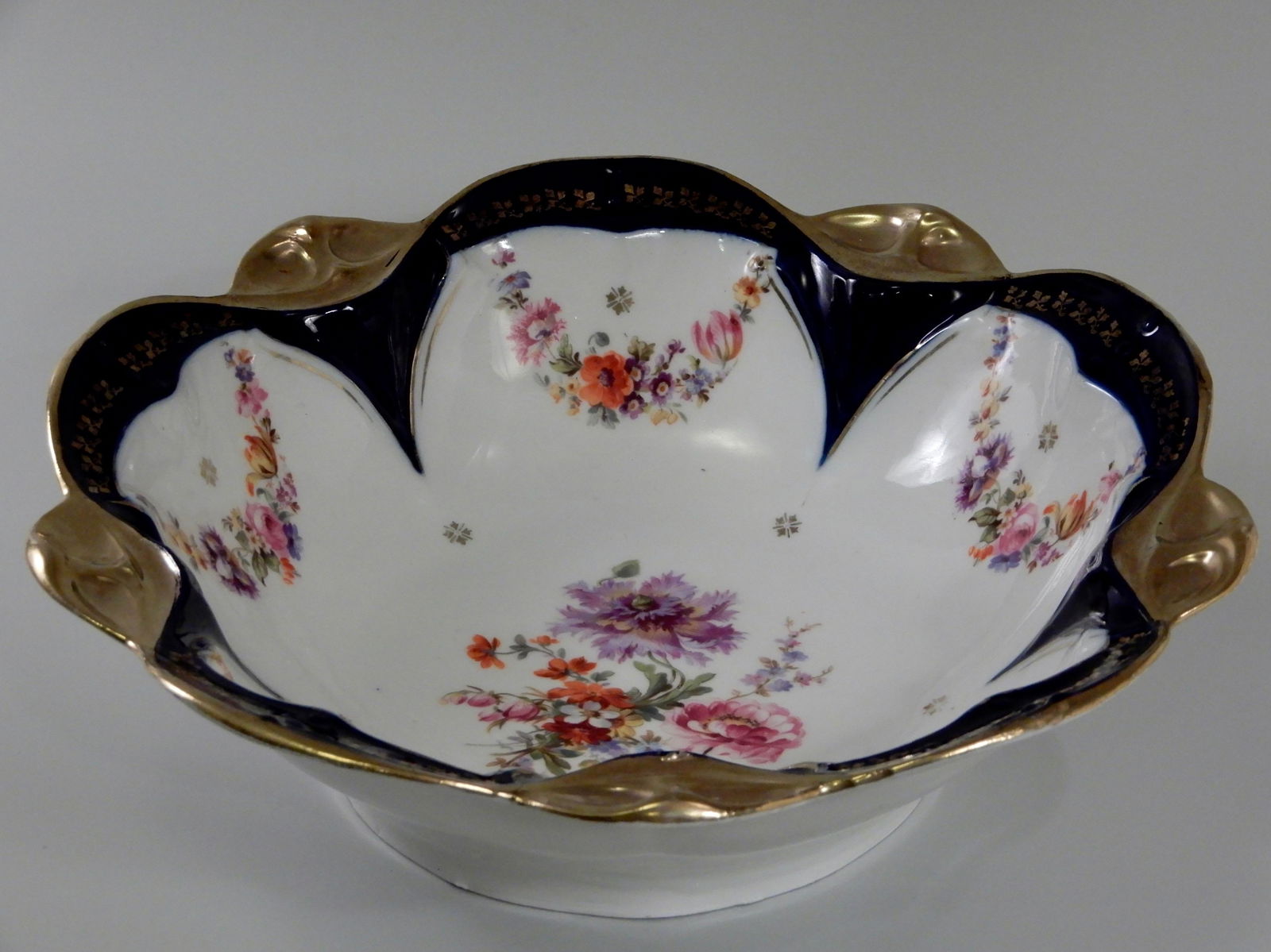 Large Antique Cobalt Porcelain Dresden Flowers Serving: Large Antique Cobalt Porcelain Dresden Flowers Serving Bowl Attributed to Carl Thieme Approximately 10 7/8 inches in diameter x 3 1/4 inches tall.