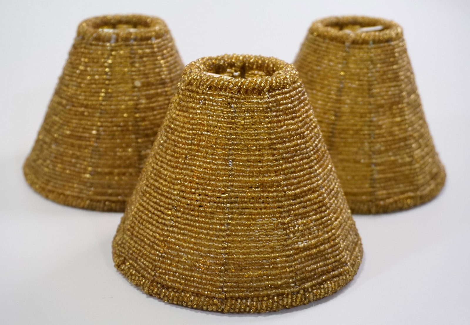 Amber Glass Beaded Lamp Shade Lot of 3 Shades: Amber Glass Beaded Lamp Shade Lot of 3 Shades Approximately 3 3/4 x 5 1/2 inches in diameter.