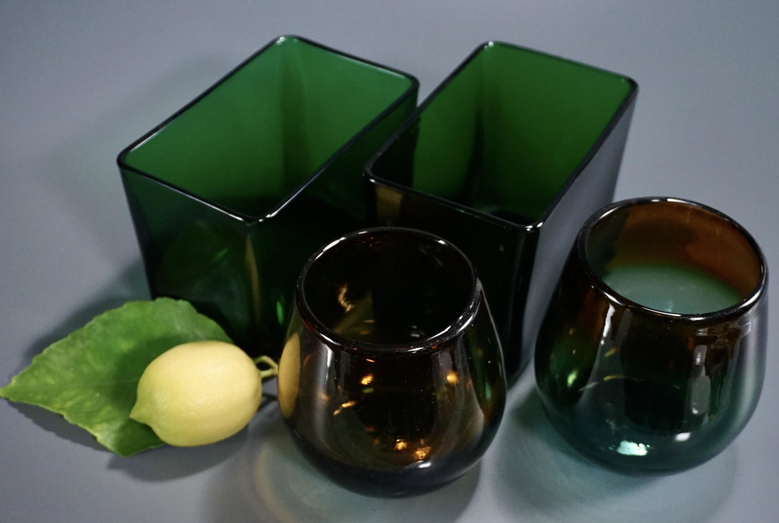 Napco Green Glass Rectangular Planter Container and: Napco Green Glass Rectangular Planter Container and Amber Green Blue Colored Vases Lot of 4 Items Approximately 3 1/2 x 5 1/2 x 4 1/8 inches and 4 1/8 inches tall x 3 1/2 inches in diameter.