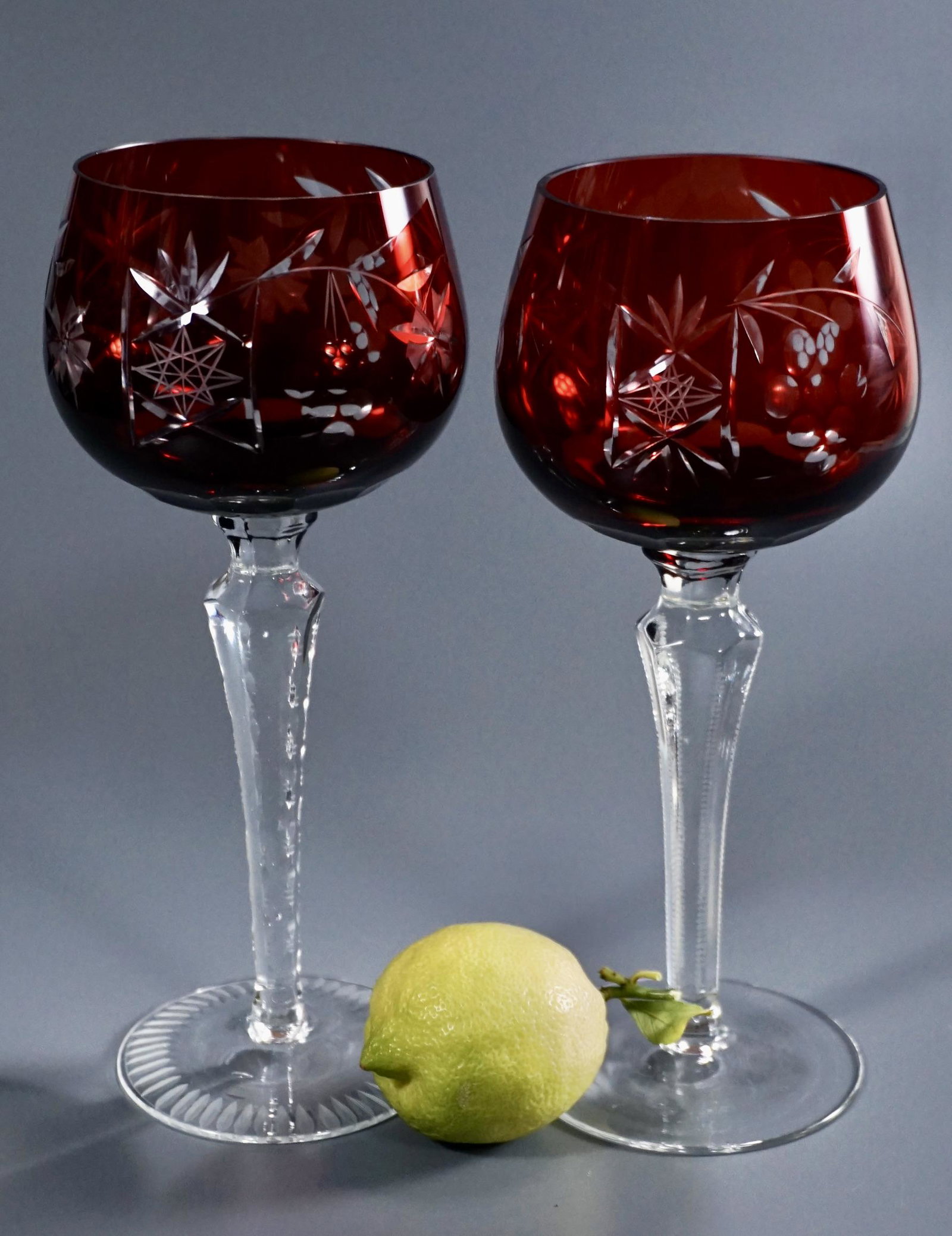 Ruby Red Cut to Clear Crystal Goblet Lot of 2 Notched: Ruby Red Cut to Clear Crystal Goblet Lot of 2 Notched Stem Grape Design Hock Wine Glasses Approximately 7 7/8 and 8 inches tall.