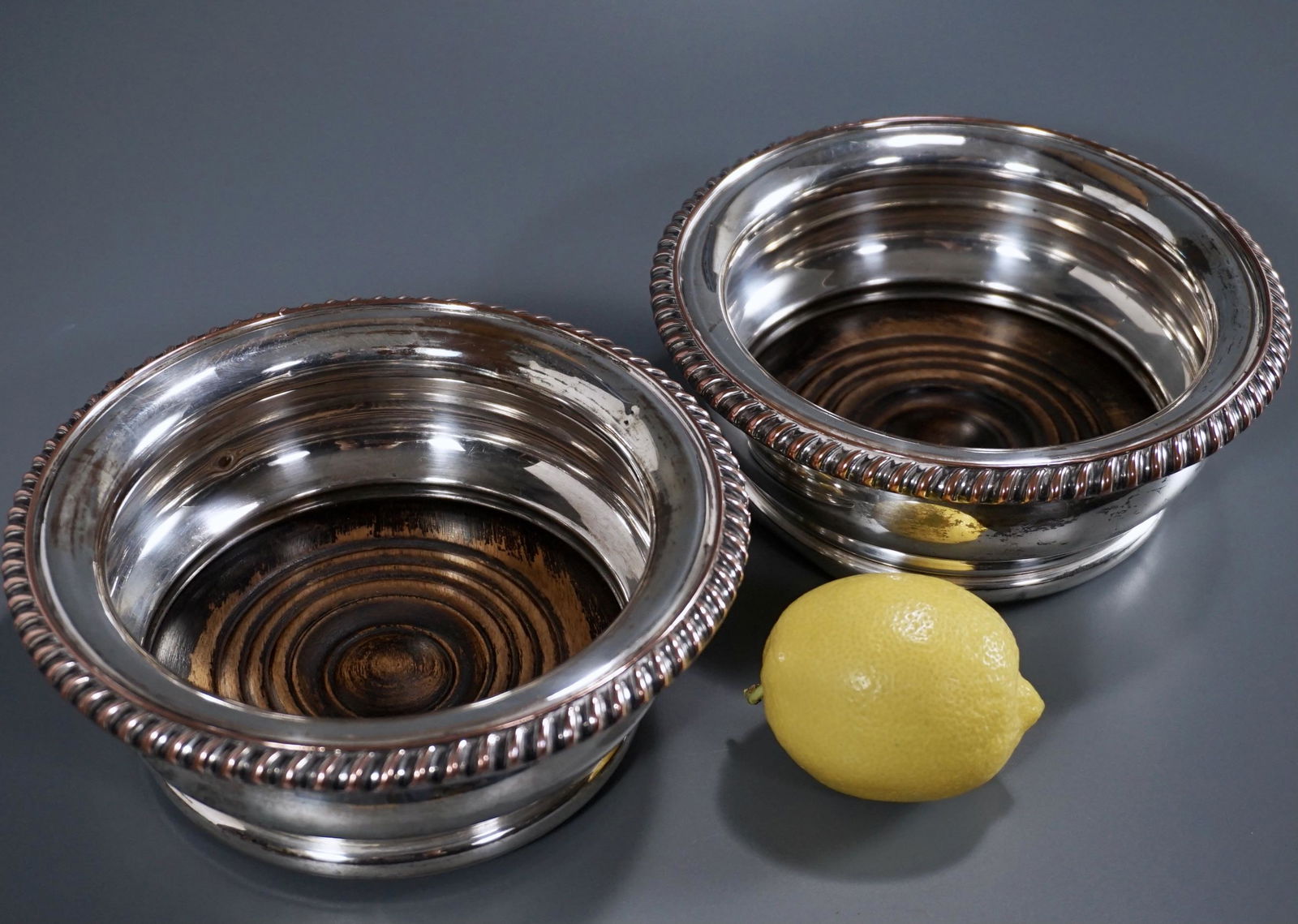 Antique Sheffield Silver on Copper Wine Bottle Coasters: Antique Sheffield Silver on Copper Wine Bottle Coasters Pair Approximately 2 1/2 inches tall x 6 5/8 inches in diameter; approximately 4 5/8 inches inner diameter.