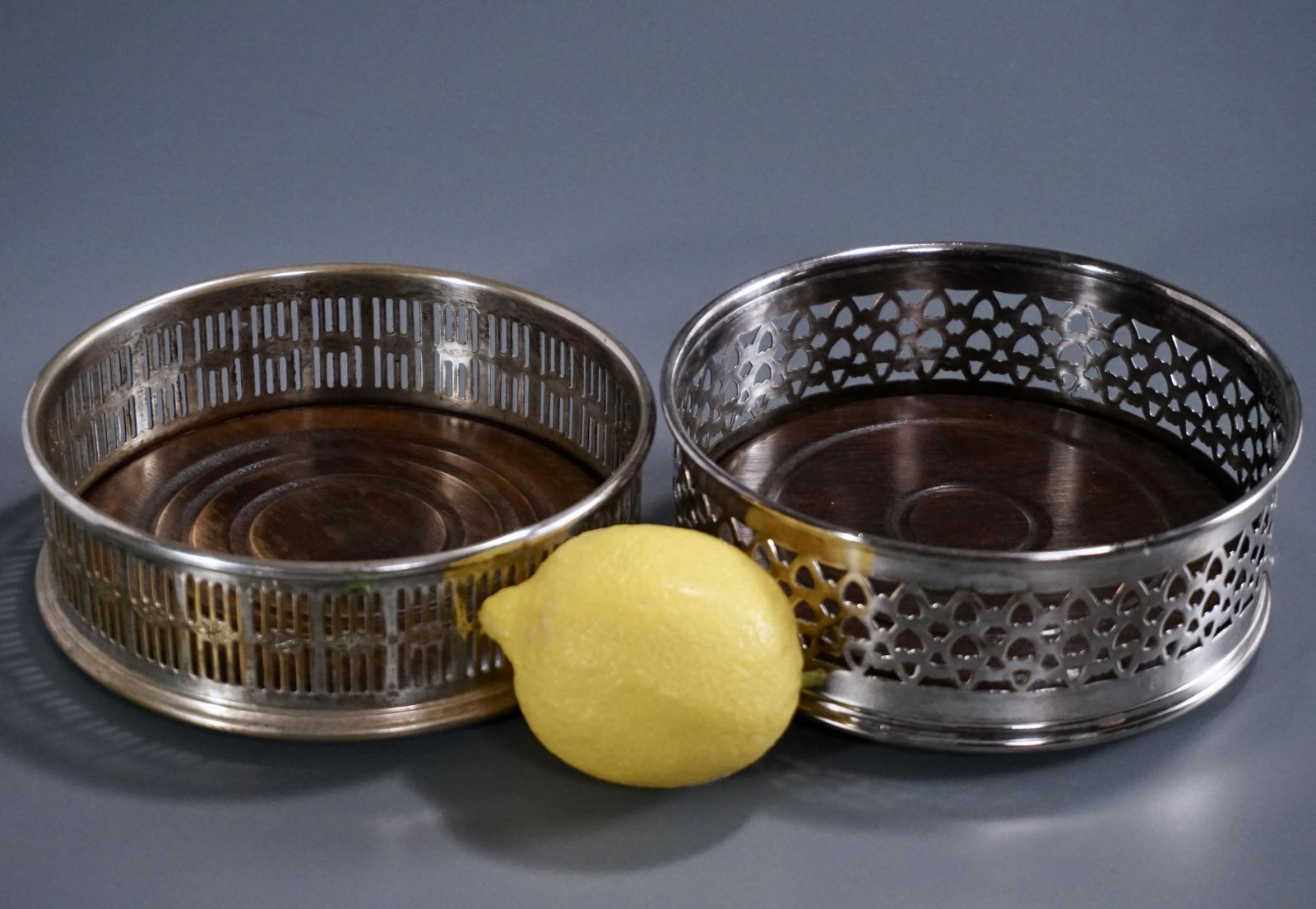 Wine Bottle Coaster Lot of 2 Pierced Metal Gallery: Wine Bottle Coaster Lot of 2 Pierced Metal Gallery Coasters Turned Wood Base Approximately 2 inches tall x 5 1/8 inches in diameter and 1 3/4 inches tall x 5 1/4 inches in diameter.