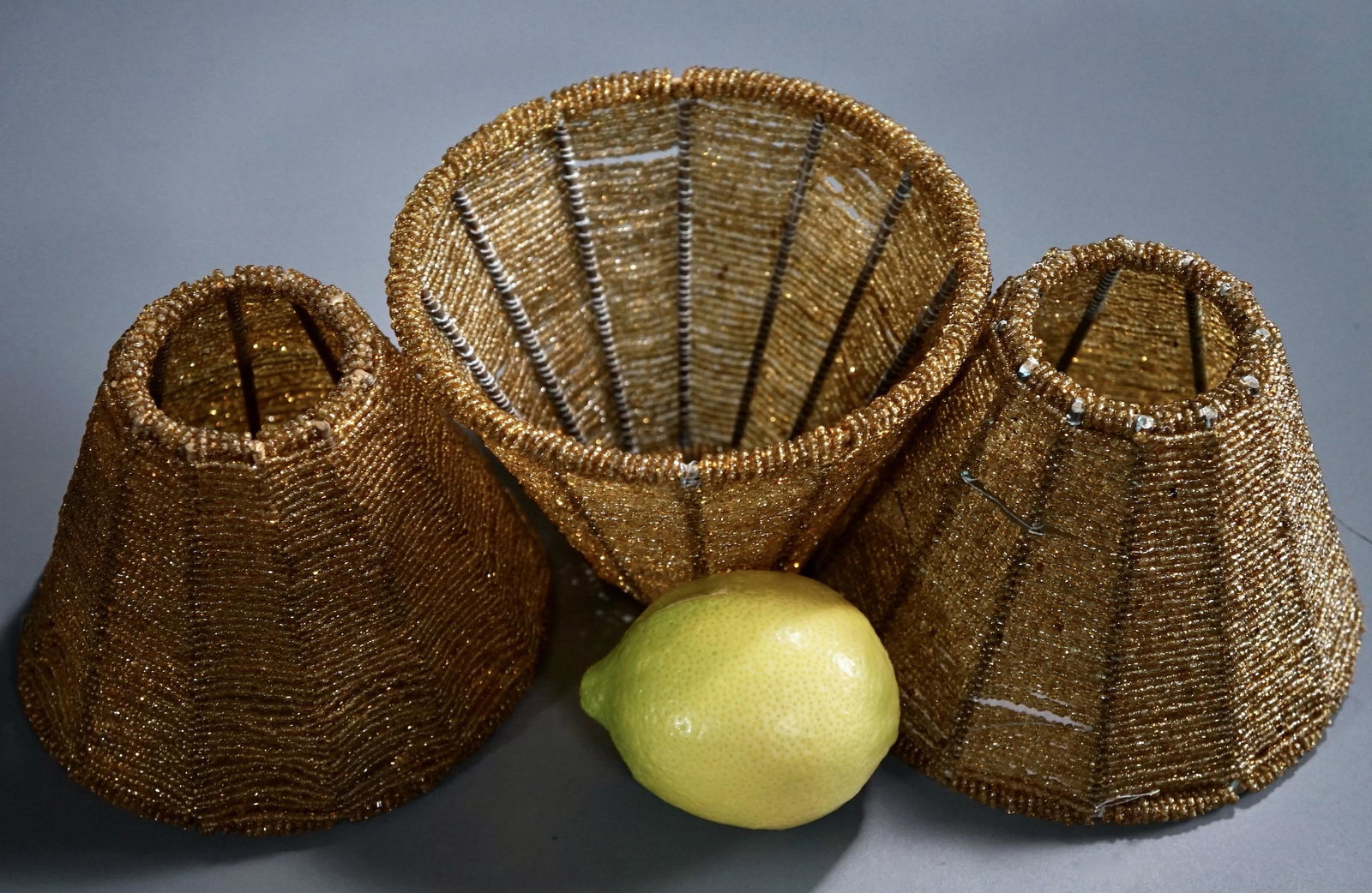 Amber Glass Seed Beaded Lamp Shade Lot of 3 Shades: Amber Glass Seed Beaded Lamp Shade Lot of 3 Shades Approximately 4 inches tall x 5 1/2 inches in diameter, 2 5/8 inches in diameter fitter opening.