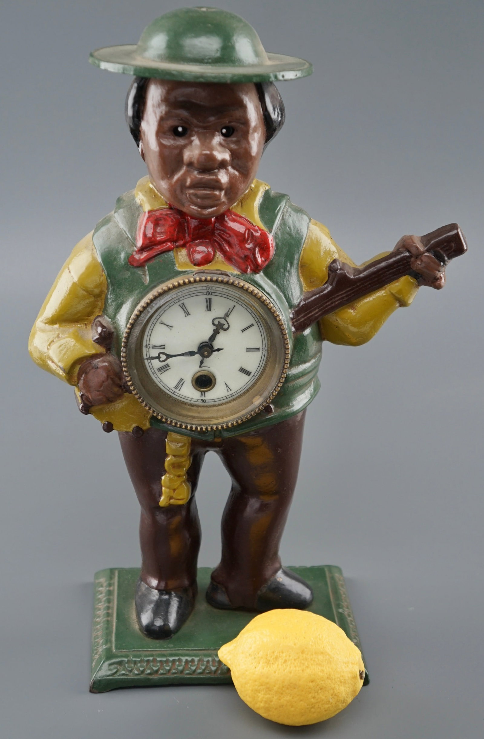 Blinking Eye Automation Painted Cast Iron Banjo Player Clock: Blinking Eye Automation Painted Cast Iron Banjo Player Clock Approximately 6 1/2 x 4 3/8 x 15 inches tall. Shipping Estimate:SHIPTHEBAY estimate for shipping of this lot in the Continental US is $20, 