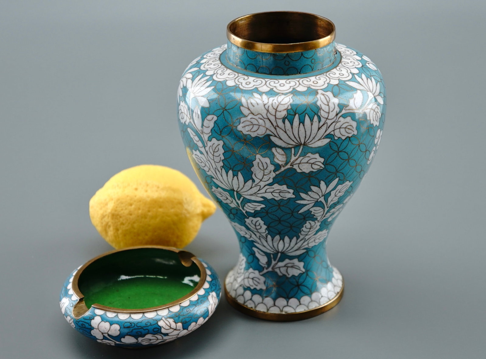 Chinese Cloisonne Enamel Vase & Ashtray: Chinese Cloisonne Enamel Vase & Ashtray The vase is approximately 6 3/4 inches tall, the ashtray is about 3 3/4 inches in diameter. Shipping Estimate:SHIPTHEBAY estimate for shipping of this lot in th