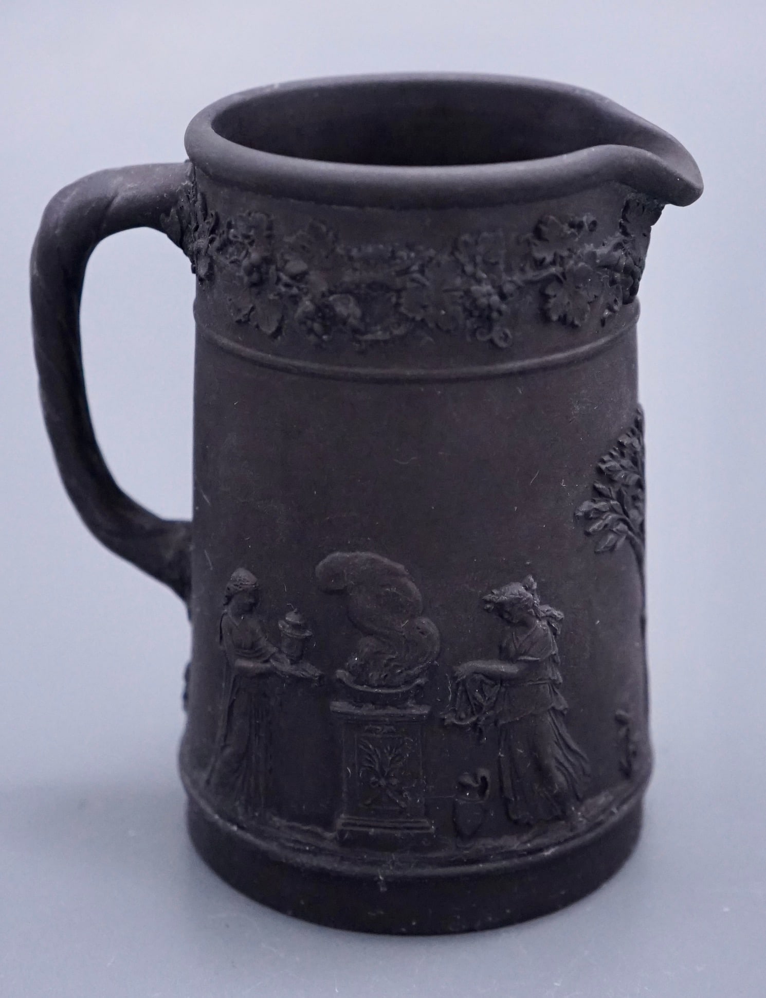 Wedgwood Black Basalt Jasper Upright Pitcher Syrup Jug Impressed Wedgwood Mark: Wedgwood Black Basalt Jasper Upright Pitcher Syrup Jug Impressed Wedgwood Mark Approximately 3 7/8 inches tall. Shipping Estimate:SHIPTHEBAY estimate for shipping of this lot in the Continental US is 