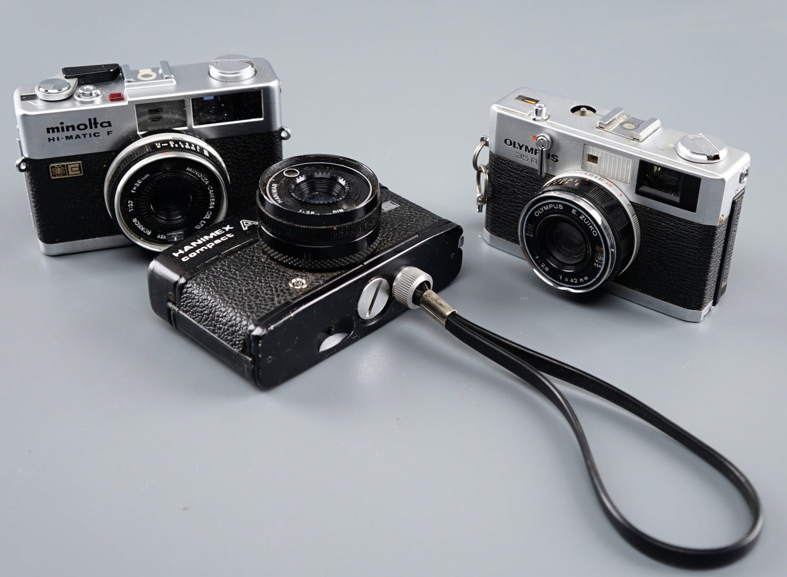 Vintage Photo Camera Olympus 35 RC Minolta Hi-Matic Hannimex Compact Collection of 3: Vintage Photo Camera Olympus 35 RC Minolta Hi-Matic Hannimex Compact Collection of 3 Approximately 4 3/4 inches wide. Shipping Estimate:SHIPTHEBAY estimate for shipping of this lot in the Continental 
