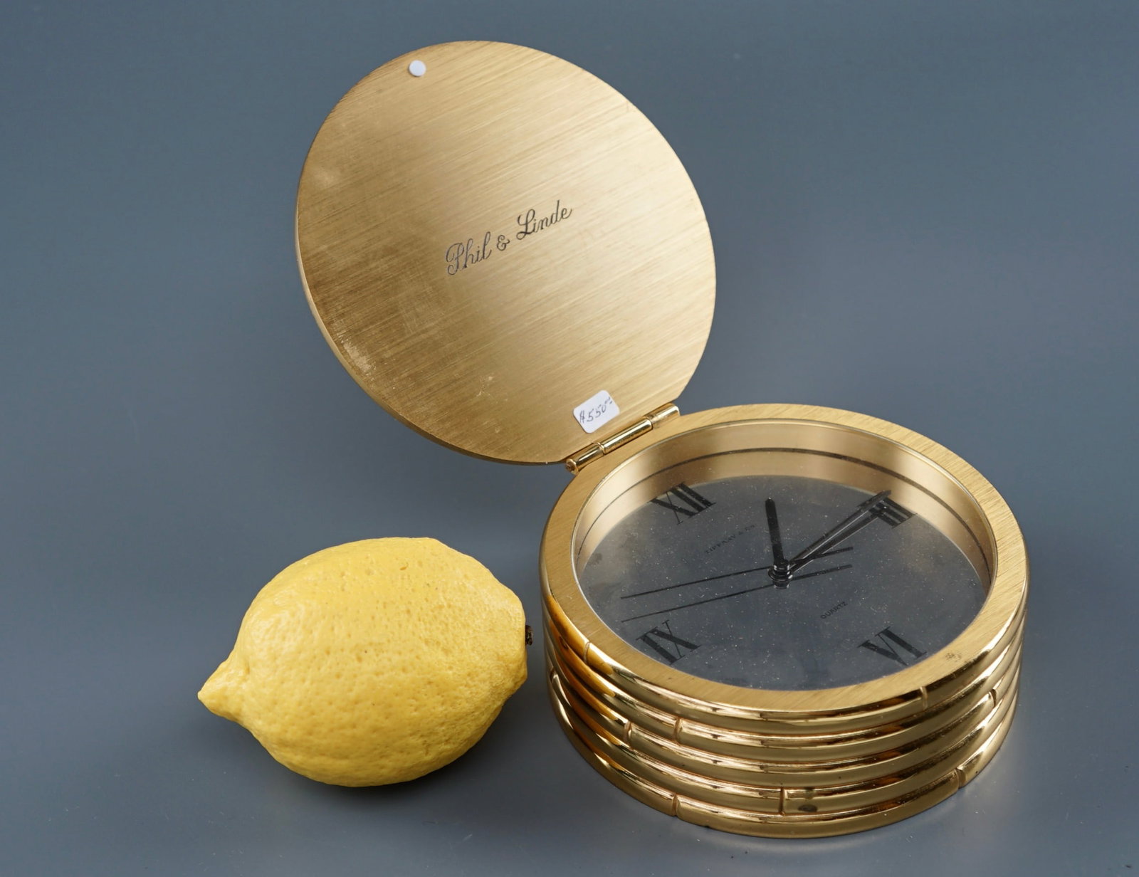 Tiffany Ormolu Bronze Clock: Tiffany Ormolu Bronze Clock Approximately 2 x 5 inches in diameter. Shipping Estimate:SHIPTHEBAY estimate for shipping of this lot in the Continental US is $20, which includes pick up, packing and act