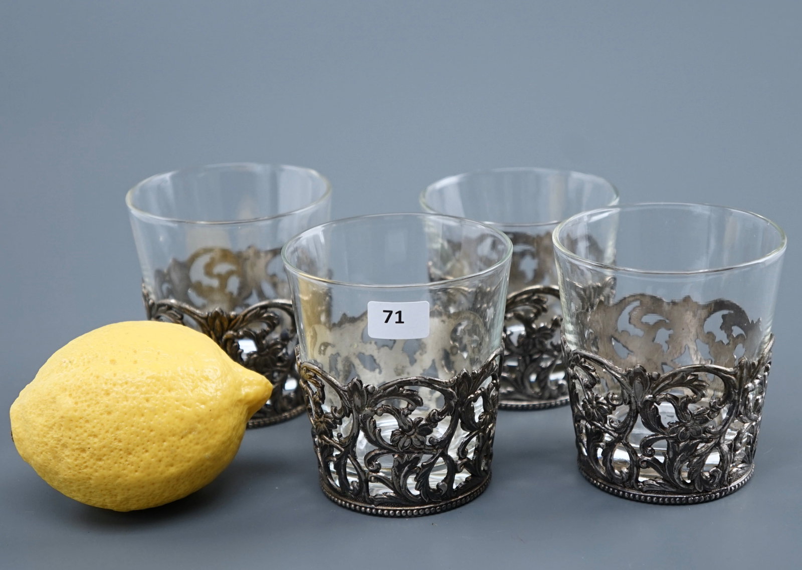 Clear Glass in Silver Plated Filigree Holder Lot of 4: Clear Glass in Silver Plated Filigree Holder Lot of 4 Approximately 3 inches in diameter x 3 1/4 inches tall. SHIPPING & PICKUP: For local customers pickup is free from 122 North Santa Cruz Ave Los Ga