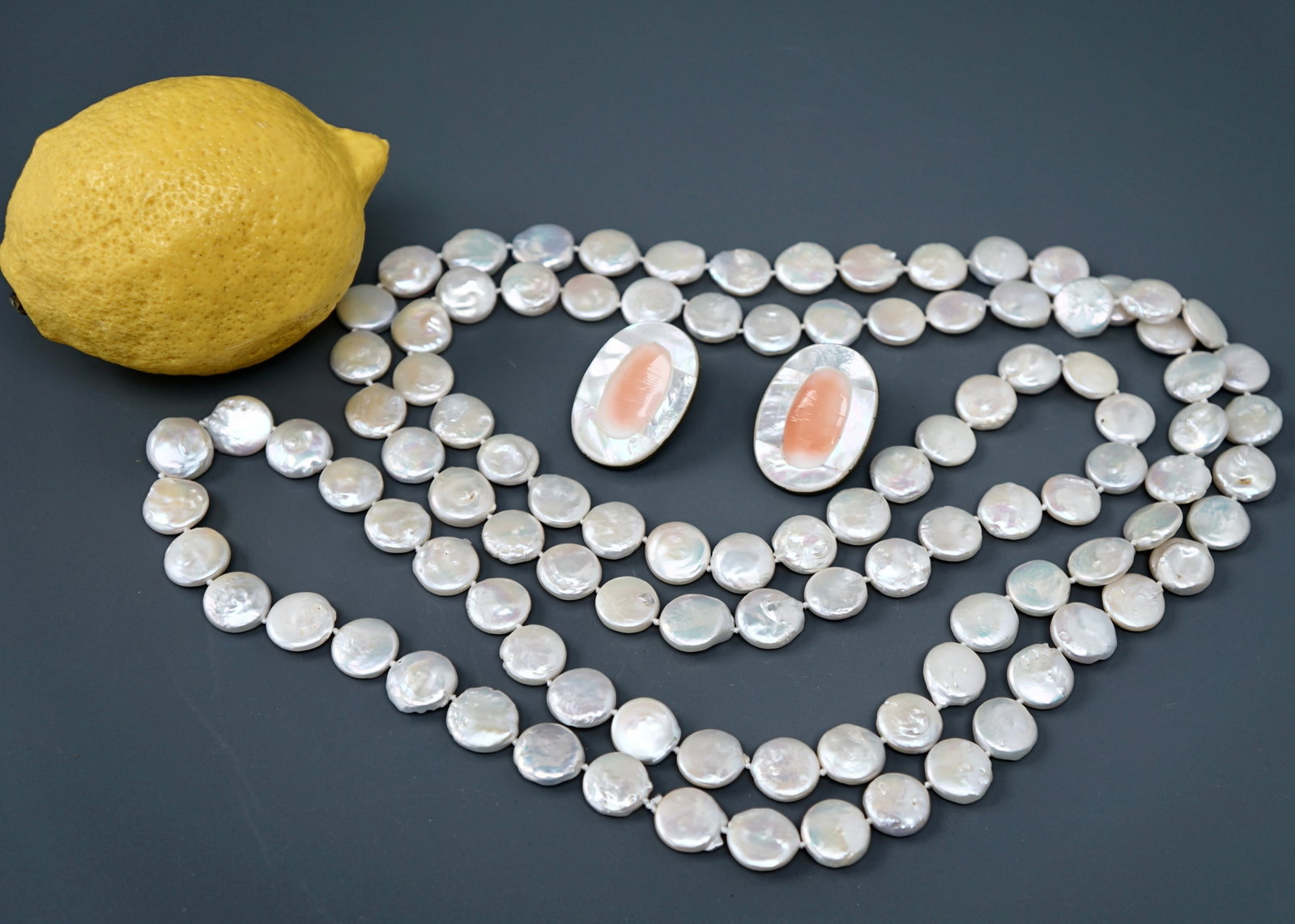 Baroque Freshwater Pearl Flat Coin Bead Long Necklace together with Mother of Pearl Earrings: Baroque Freshwater Pearl Flat Coin Bead Long Necklace together with Mother of Pearl Earrings Approximately 30 inches long (60 inches side to side); the earrings are about 1 1/16 x 1 7/16 inches. SHIPP