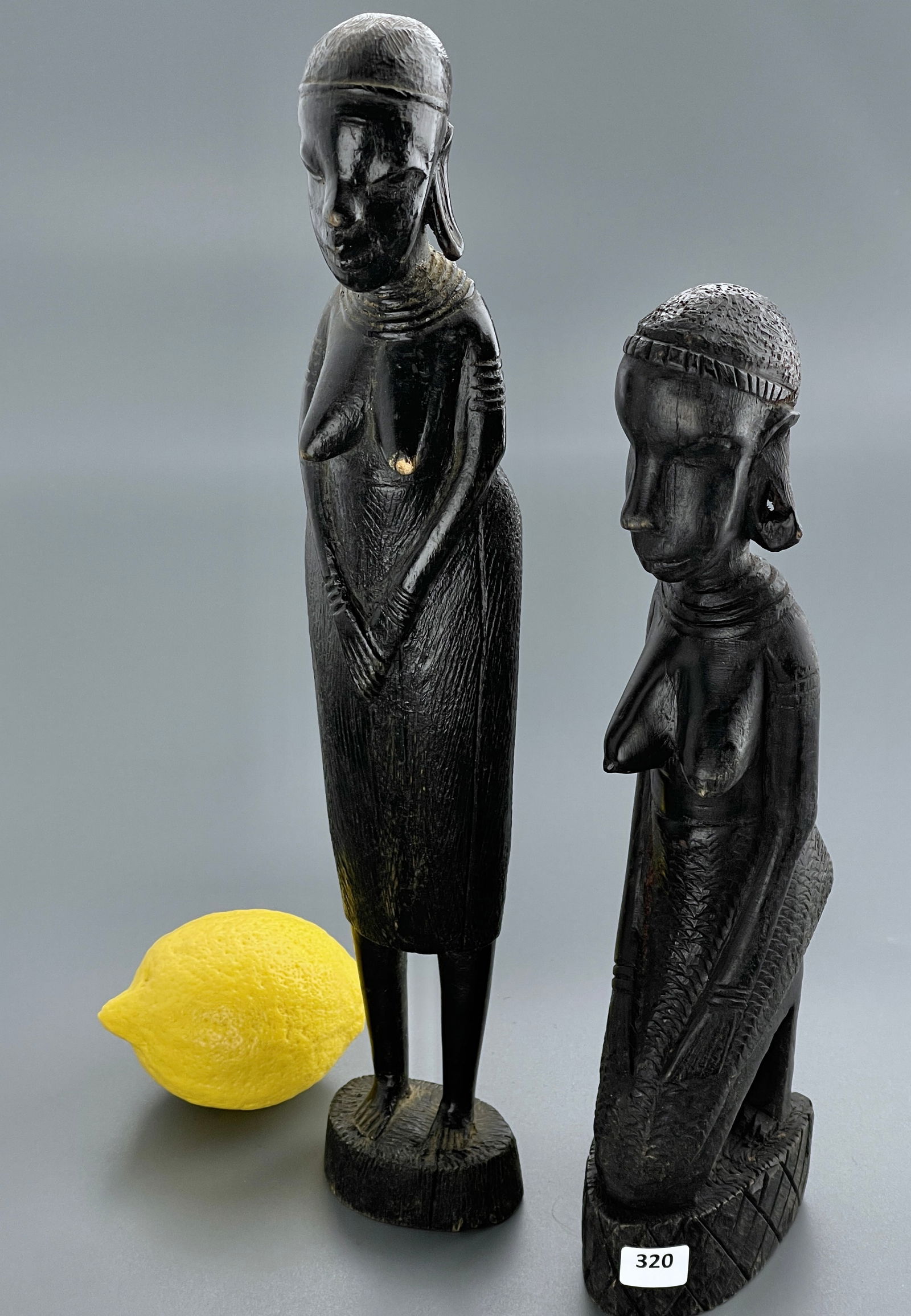African Woman Ebony Wood Carved Figurines Lot of 2 One is Labeled Genuine Besmo Product Hand Carved: African Woman Ebony Wood Carved Figurines Lot of 2 One is Labeled Genuine Besmo Product Hand Carved In Kenya Approximately 13 7/8 and 11 1/4 inches tall.