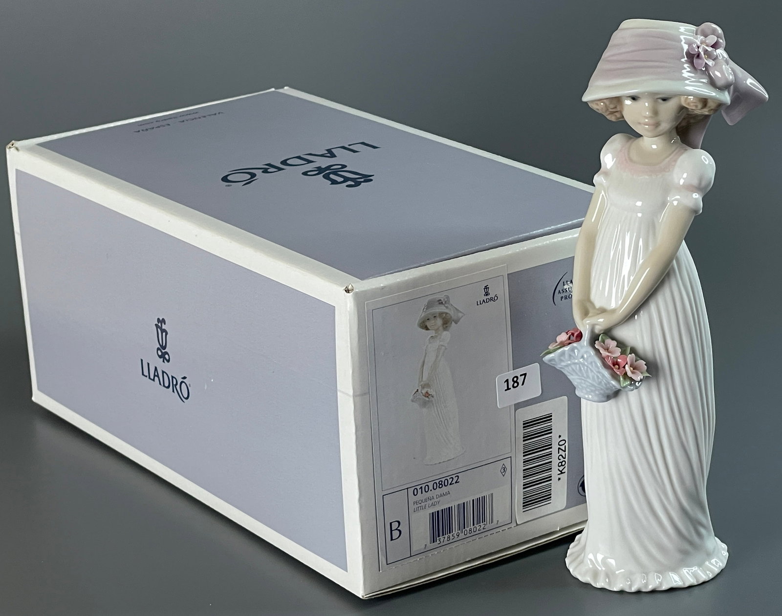 Lladro Pequena Dama Little Lady 010.08022 was designed by Regino Torrijos with a glazed finish. (1 of 5)