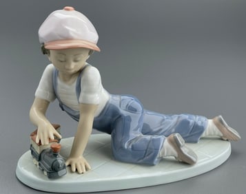 Lladro Collectors Society Exclusive Porcelain Figurine of a Boy in Conductor Hat Playing with a Toy