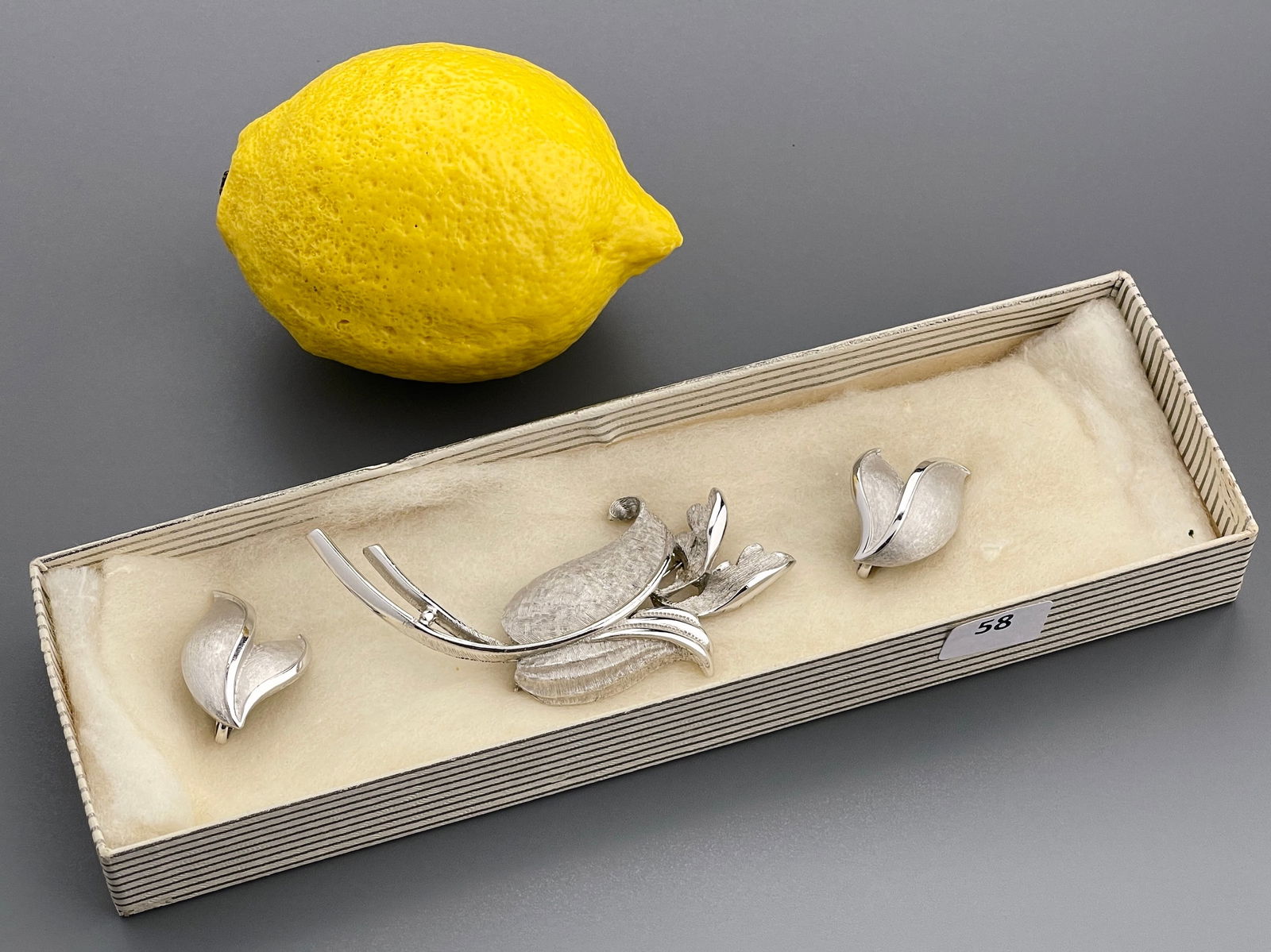 Vintage Costume Jewelry Trifari Clip Earrings & Large Matching Tulipe Flower Brushed White Metal: Vintage Costume Jewelry Trifari Clip Earrings & Large Matching Tulipe Flower Brushed White Metal Brooch Brooch is approximately 1 1/2 x 3 1/2 inches, the earrings approximately 1 1/4 x 3/4 inches.