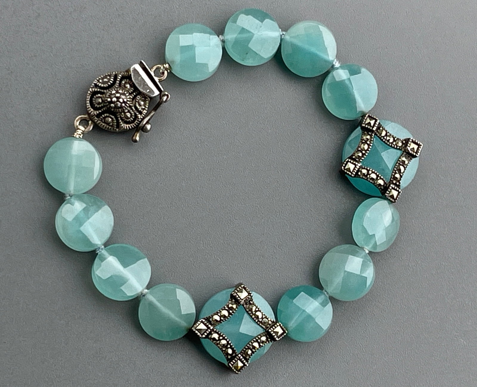 Blue Faceted Glass Marcasite Bracelet with Sterling Clasp: Blue Faceted Glass Marcasite Bracelet with Sterling Clasp Approximately 6 1/2 inches side to side.