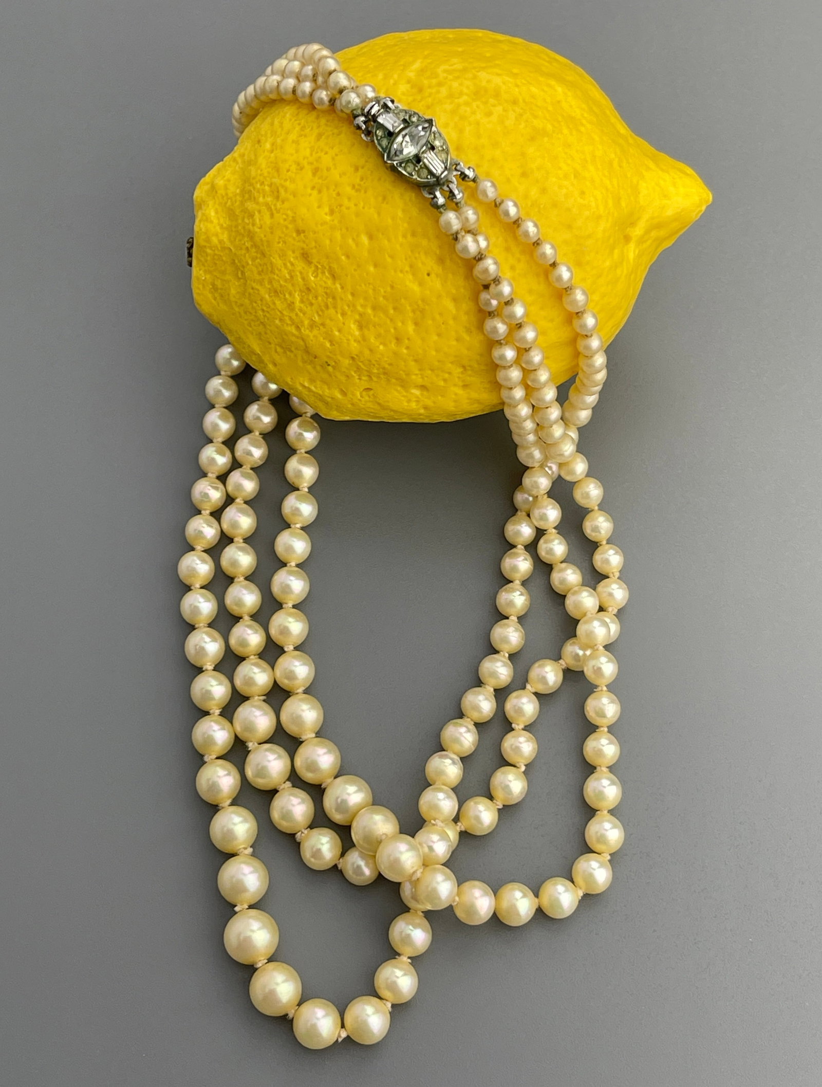 Art Deco Graduated Faux Pearl Triple String Necklace with Jeweled Faux Diamonds Clasp: Art Deco Graduated Faux Pearl Triple String Necklace with Jeweled Faux Diamonds Clasp Approximately 15 inches side to side.