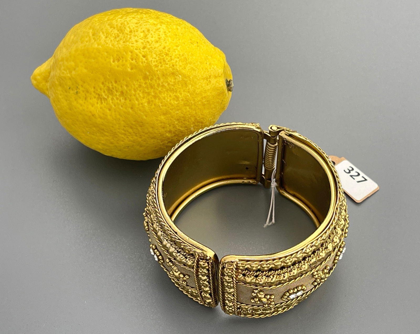 Ethnic Style Gold Tone Metal Jeweled Wide Cuff Hinged Bracelet: Ethnic Style Gold Tone Metal Jeweled Wide Cuff Hinged Bracelet Approximately 3 x 3 5/8 x 1 1/2 inches wide.