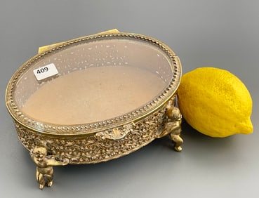 Vintage Beveled Glass Jewelry Casket Figural Putti Filigree Pierced Brass Oval Trinket Box