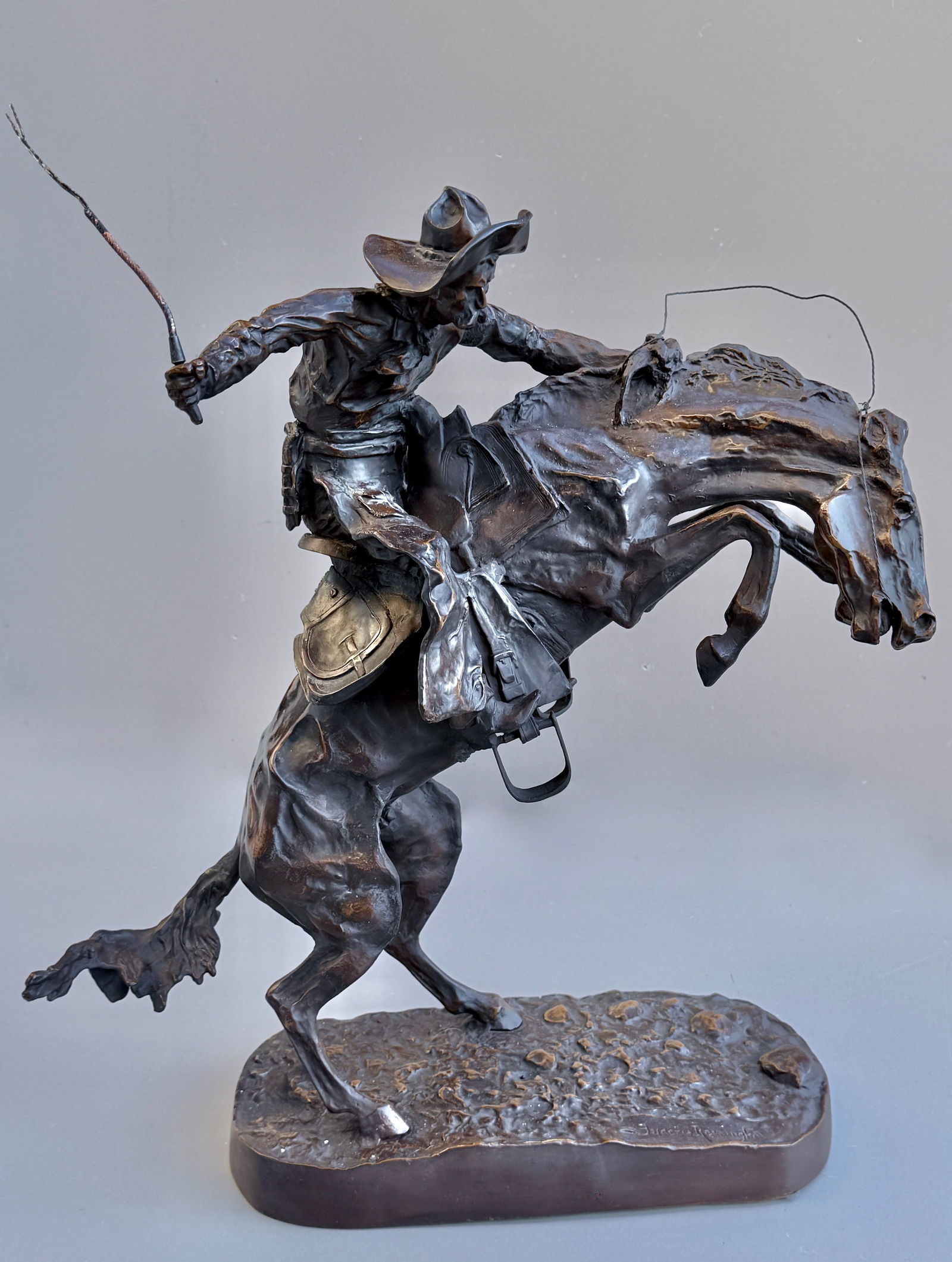 The Bronco Buster Bronze by Frederic Remington after the original sculpture modeled in 1895 which: The Bronco Buster Bronze by Frederic Remington after the original sculpture modeled in 1895 which currently resided in the White House. Overall dimensions are approximately 21 inches wide x 12 inches