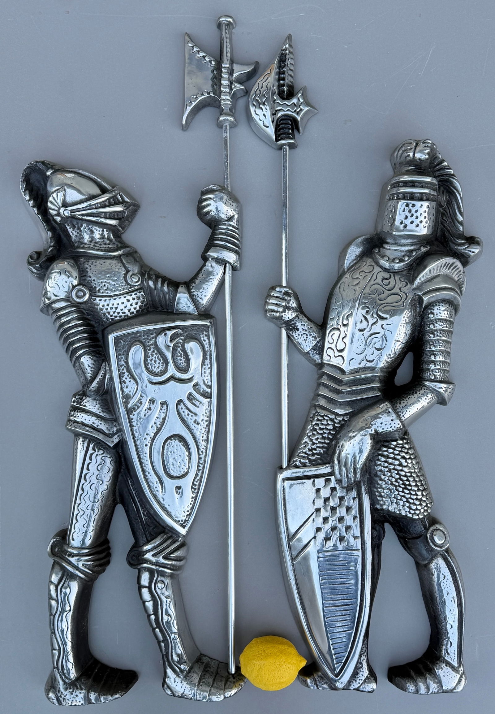 Large Medieval Knights in Armor Holding Weapons and Shields Vintage Cast Aluminum Wall Plaques Mid: Large Medieval Knights in Armor Holding Weapons and Shields Vintage Cast Aluminum Wall Plaques Mid Century Decor Approximately 34 x 11 1/2 inches and 32 1/2 x 11 1/2 inches.