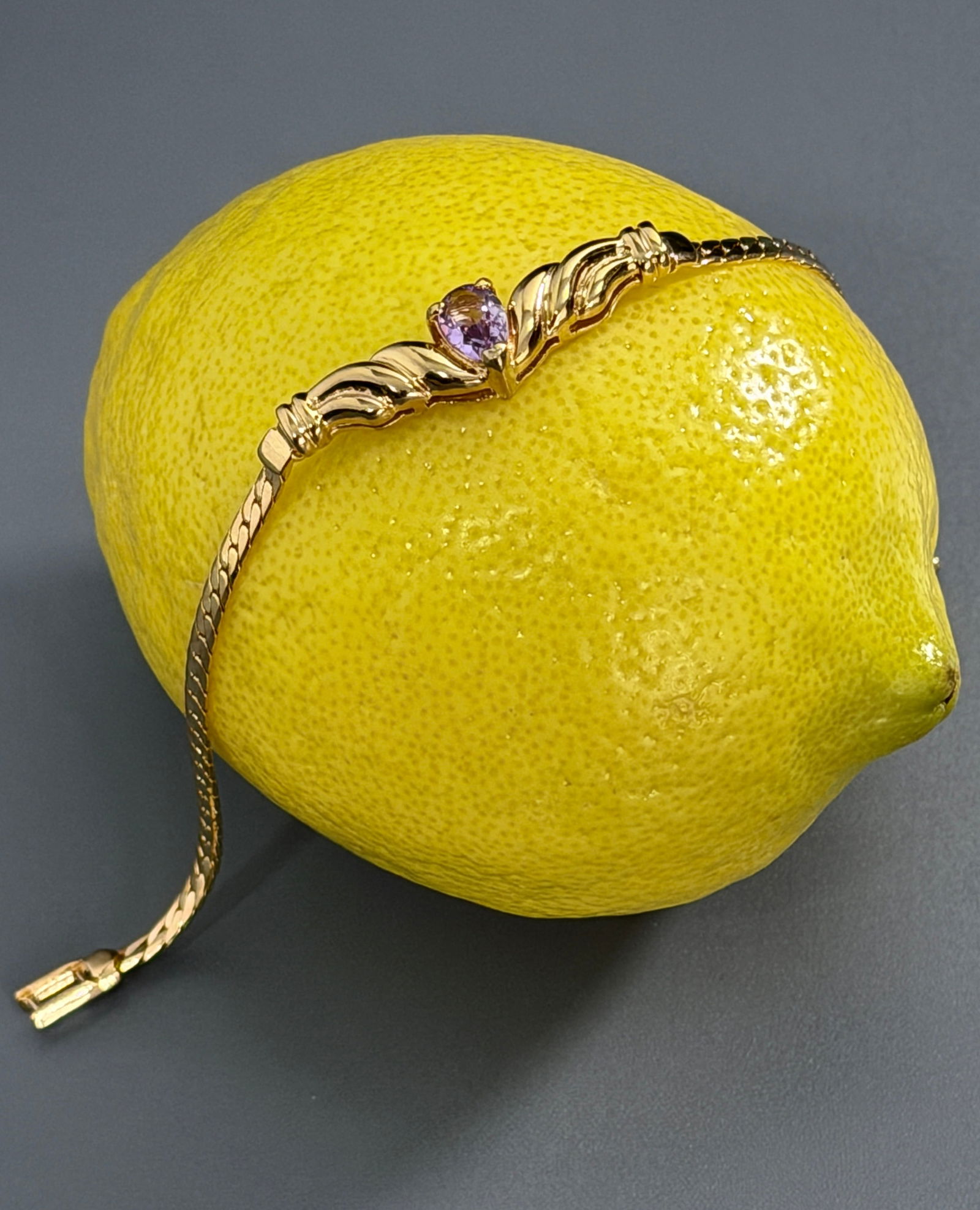 Vintage Amethyst Colored Stone Gold Tone Bracelet: Vintage Amethyst Colored Stone Gold Tone Bracelet Approximately 7 1/2 inches side to side.