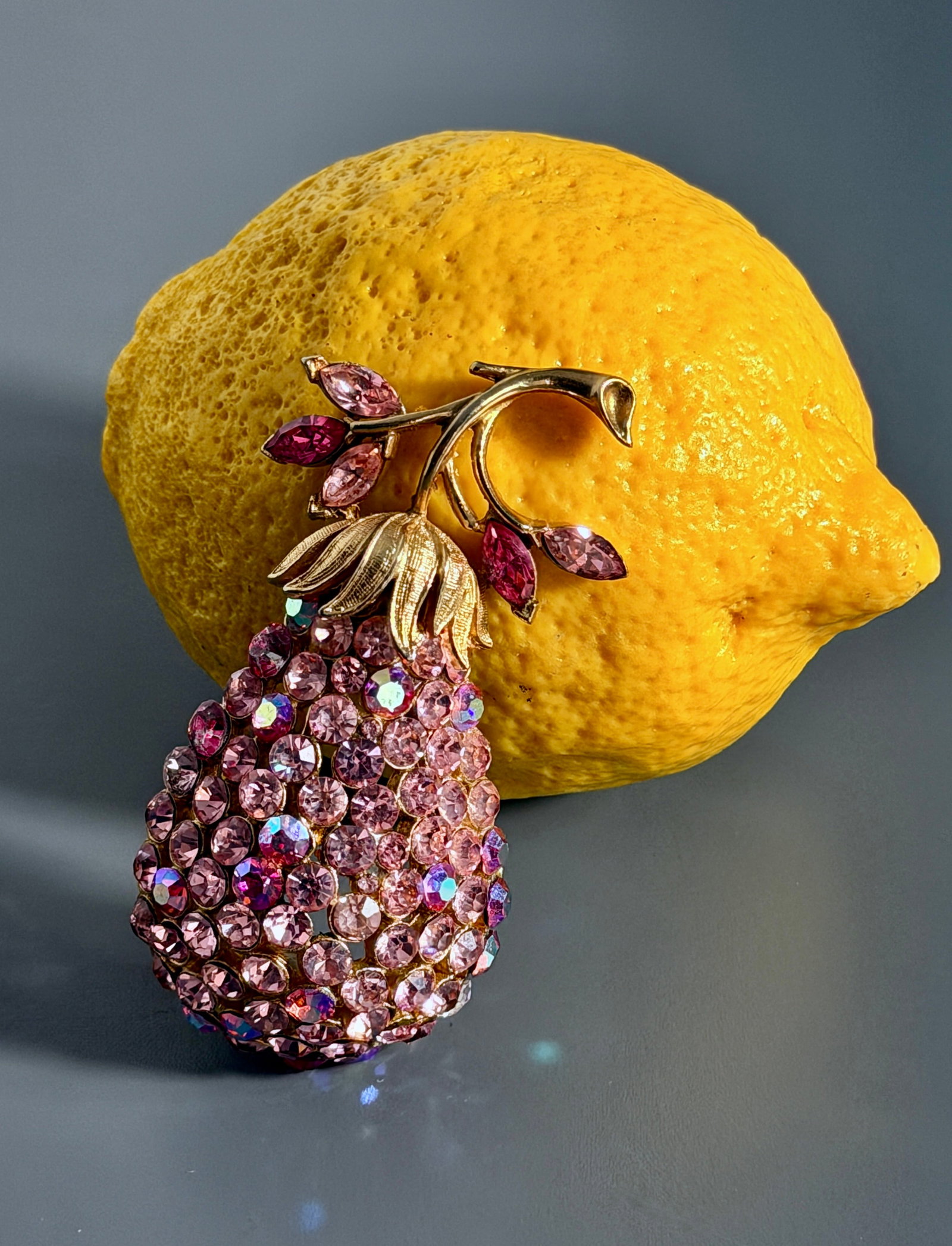 Vintage Rhinestone Pear Gold Tone Pink Aurora Borealis Fruit Brooch Pin: Vintage Rhinestone Pear Gold Tone Pink Aurora Borealis Fruit Brooch Pin Approximately 3 x 1 5/8 x 5/8 inches.