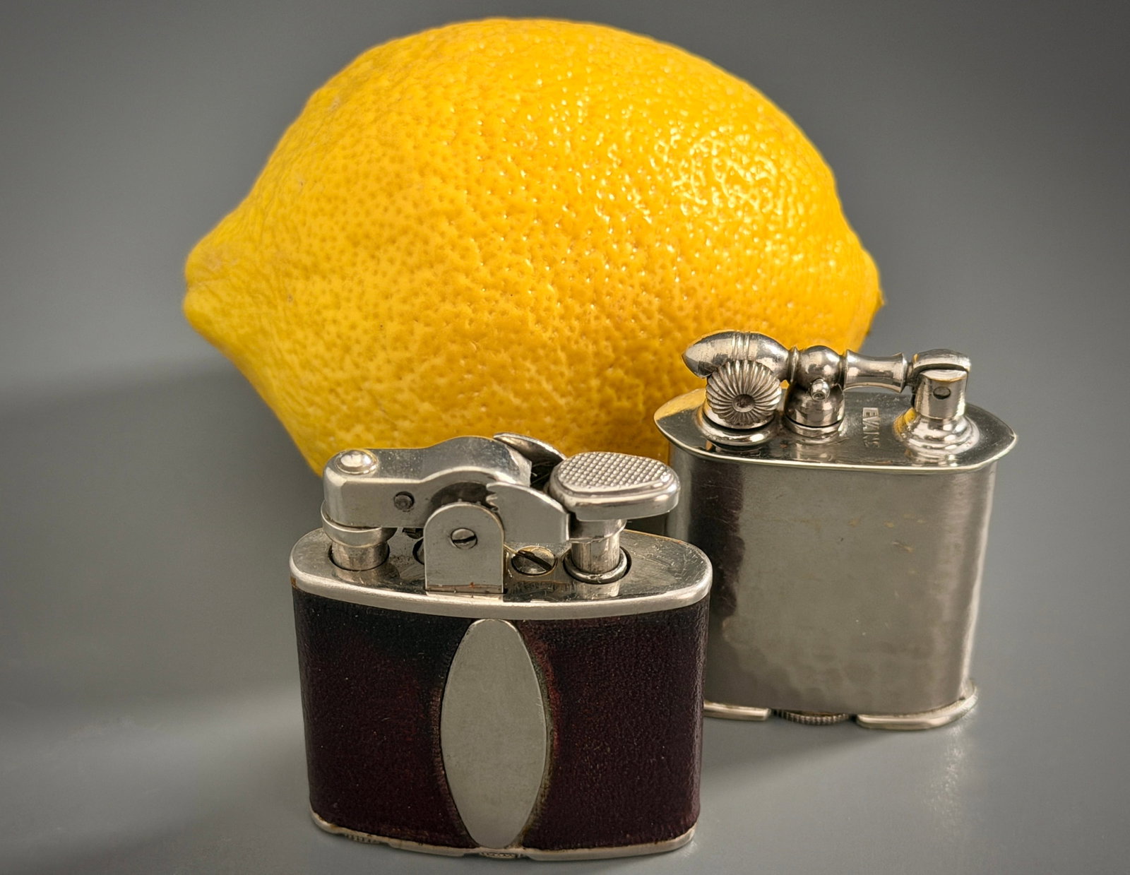 Vintage Evans Hammered Chrome Pocket Lighter Ronson Leatherette Automatic Lighter Classic American: Vintage Evans Hammered Chrome Pocket Lighter Ronson Leatherette Automatic Lighter Classic American Tobaccoriana Lot of 2 Approximately 1 7/8 x 1 5/8 x 9/16 inches and 1 7/8 x 1 3/8 x 9/16 inches.