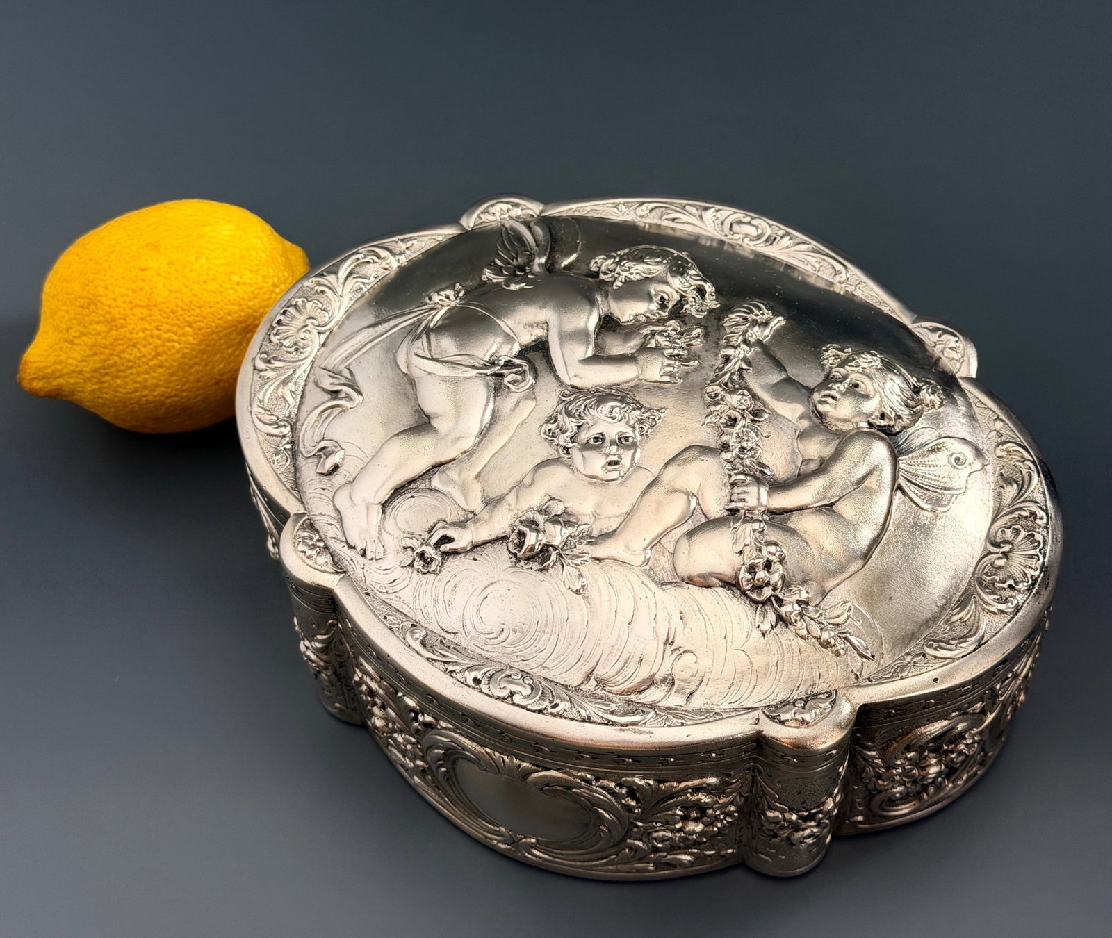 Antique German Hanau Solid Silver Cherub Putti Repousse Casket Hinged Jewelry Box Repousse Lid Putti: Antique German Hanau Solid Silver Cherub Putti Repousse Casket Hinged Jewelry Box Repousse Lid Putti Winged Cherubs Swirling Clouds Allegorical Scene Chased Rococo Scrollwork Floral Sprays and Cartouc