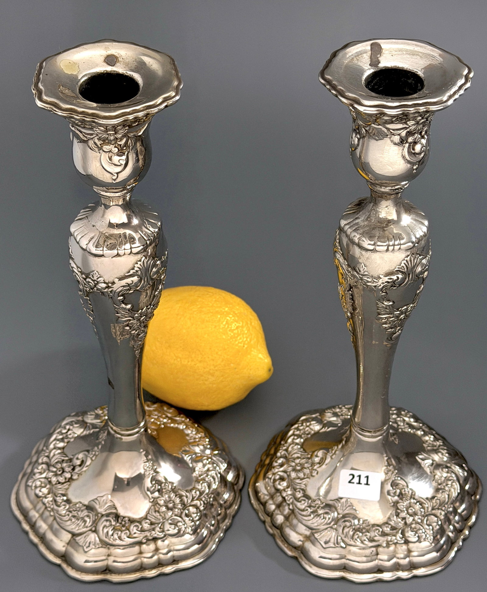 Antique Silver Plated Repousse Candlesticks Pair Floral Rococo Baluster Column Stem Original Green: Antique Silver Plated Repousse Candlesticks Pair Floral Rococo Baluster Column Stem Original Green Felt Pads Approximately 9 1/4 inches tall on 4 3/8 inches in diameter base.