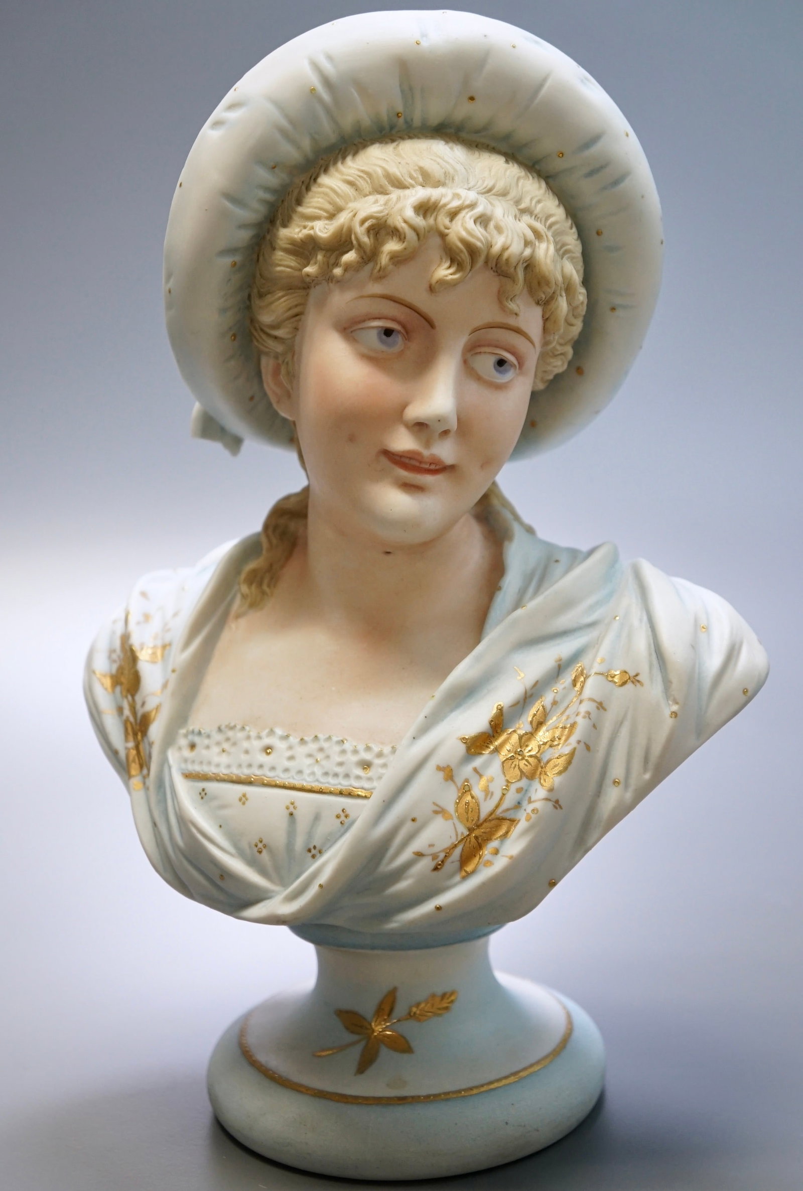 Antique Bisque Porcelain Bust Young Woman Bonnet Gold Accents: Antique Bisque Porcelain Bust Young Woman Bonnet Gold Accents Approximately 7 1/8 x 4 3/8 x 10 inches tall.