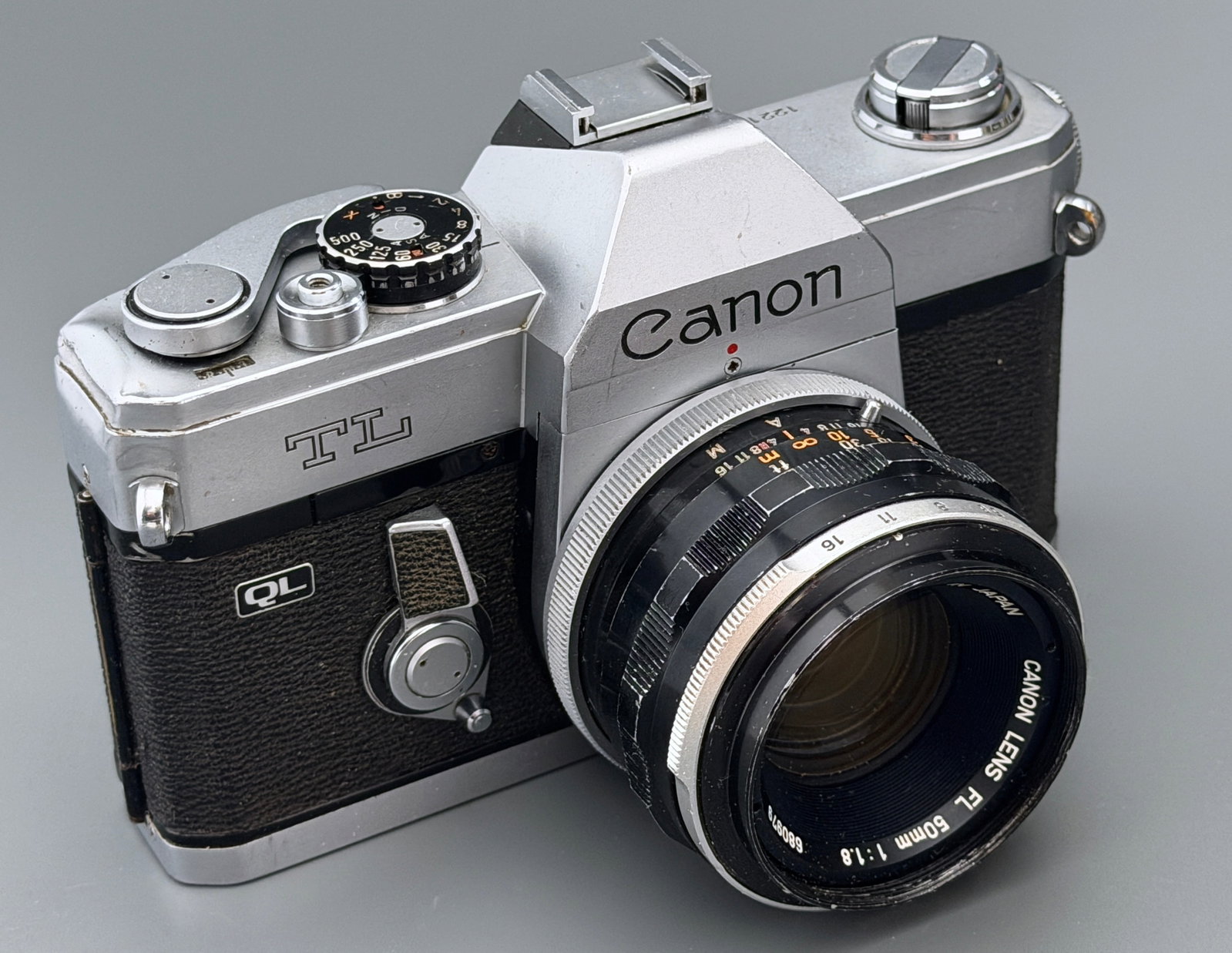 Vintage Canon TL QL 35mm SLR Film Camera Body Serial 122107 with Canon FL 50mm f1.8 Lens 680979: Vintage Canon TL QL 35mm SLR Film Camera Body Serial 122107 with Canon FL 50mm f1.8 Lens 680979 Quick Load System Japan Repair Lot Approximately 5 5/8 x 3 5/8 x 3 3/4 inches.