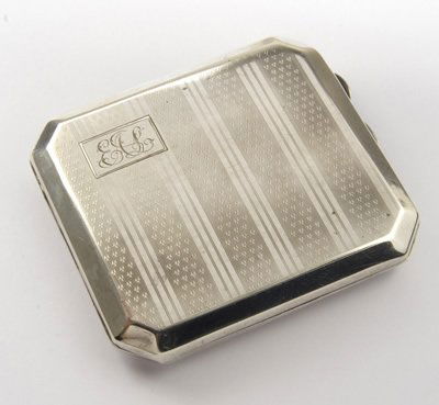 Silver cigarette case: Silver cigarette case, approx. 95mm x 85mm, engine turned pattern with monogrammed corner , inner is inscribed 'Appreciation P.A.D & U.S. Ernest A Lloyd,D253 Producer, " Nothing but the Truth", Oct 19