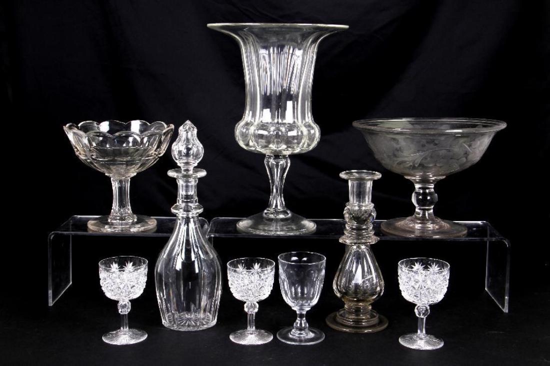 9 PIECES OF AMERICAN OR ENGLISH CUT GLASS TABLE WARE: 19TH CENTURY COMPRISING CAMPAGNA FORM VASE, HEIGHT 13 1/2 INCHES; DECANTER; CANDLESTICK; 2 COMPORTS, GREATEST DIAMETER 10 INCHES AND 4 WINE GLASSES.