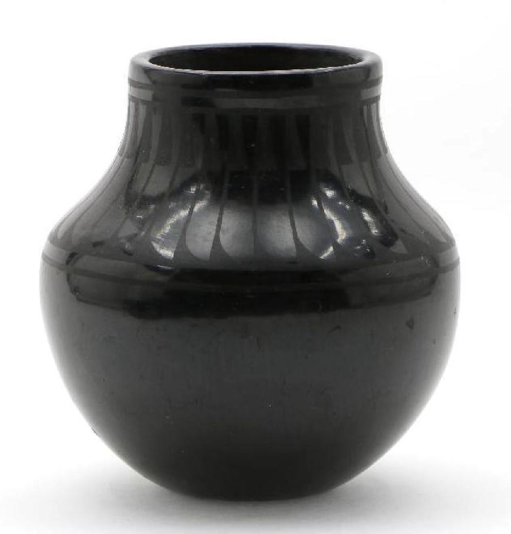 San Ildefonso blackware pottery jar: Signed Blue Corn. Height: 6 1/4 inches Width: 6 inches