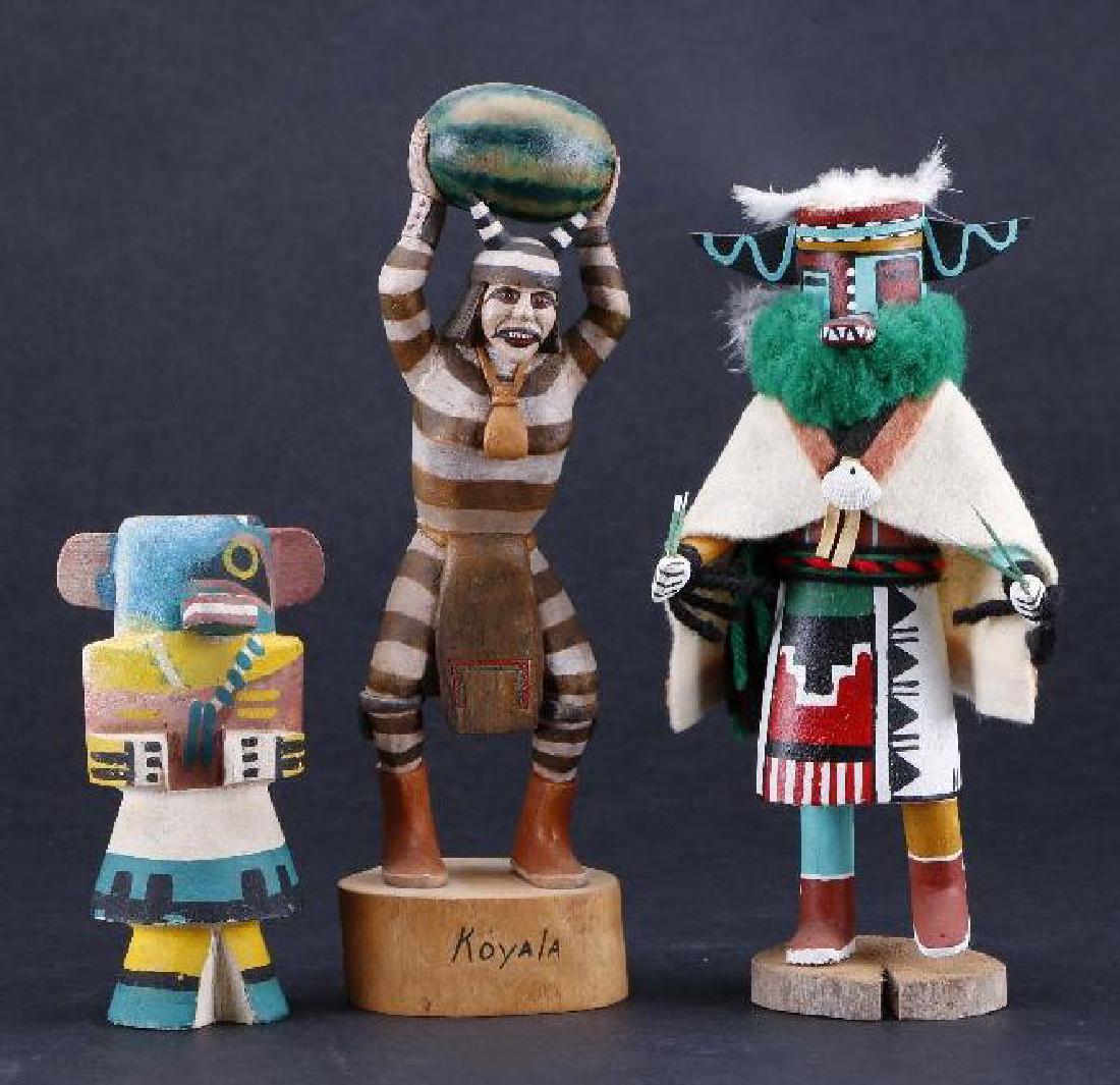 Three Hopi katsina dolls: Including Whipper katsina, by William Koots, a Koyemsi clown, and a "route 66" carving of Sipikne, a Warrior katsina. Greatest example height: 9 3/4 inches 