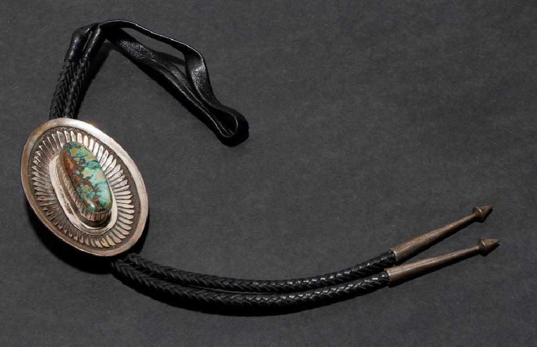 NAVAJO TURQUOISE STERLING BOLO TIE: Vintage Pawn Navajo Bolo Tie. Turquoise and sterling silver. The largest example is approximately 3 1/2 inches length (bolo only, not including the leather