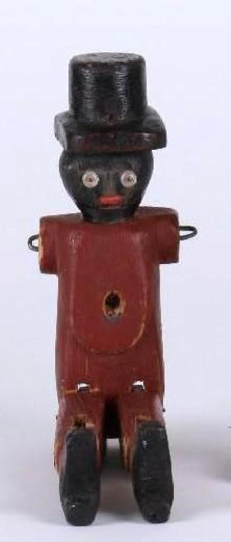 VINTAGE BLACK FOLK ART 'DANCIN DAN' FIGURE: CARVED PAINTED WOOD WITH TOP HAT, HEIGHT 11 3/4 INCHES, ONE FOOT A LATER REPLACEMENT.