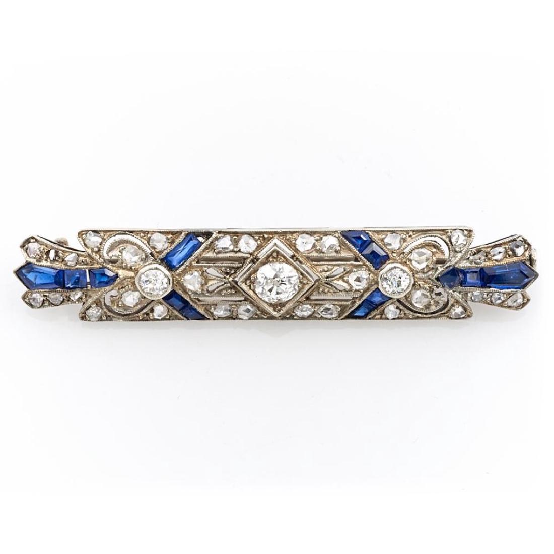 Diamond, synthetic sapphire and platinum bar brooch: Art Deco brooch set with European and rose-cut diamonds, weighing in total approximately 0.90ct; with European marks; length: 2 in. (loss of one diamond and sapphire)