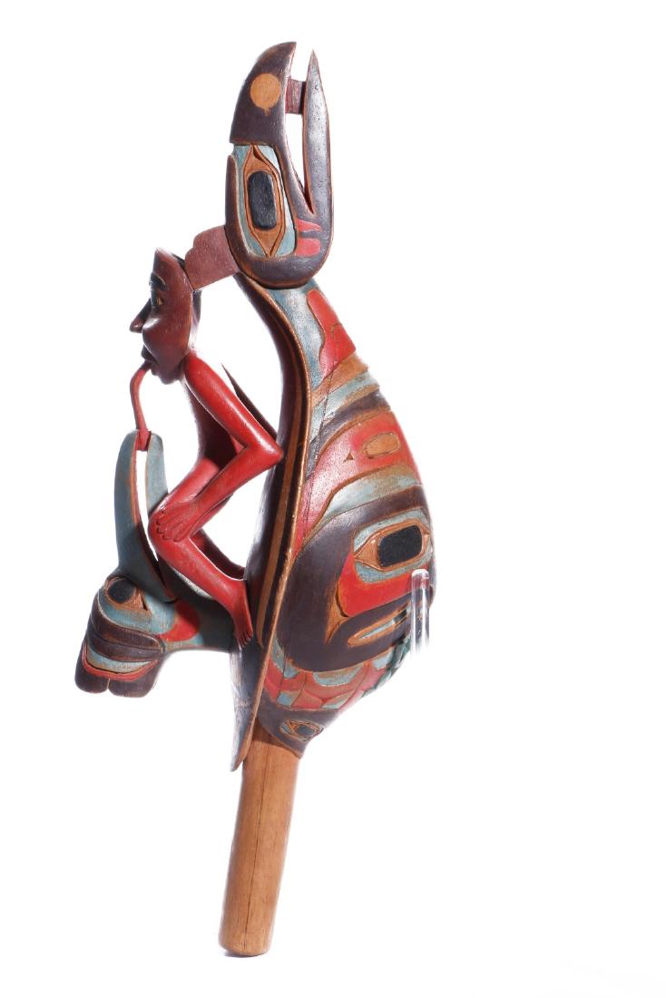 NORTHWEST COAST-STYLE RAVEN RATTLE: Probably of Indonesian manufacture. Length 17 1/2 inches